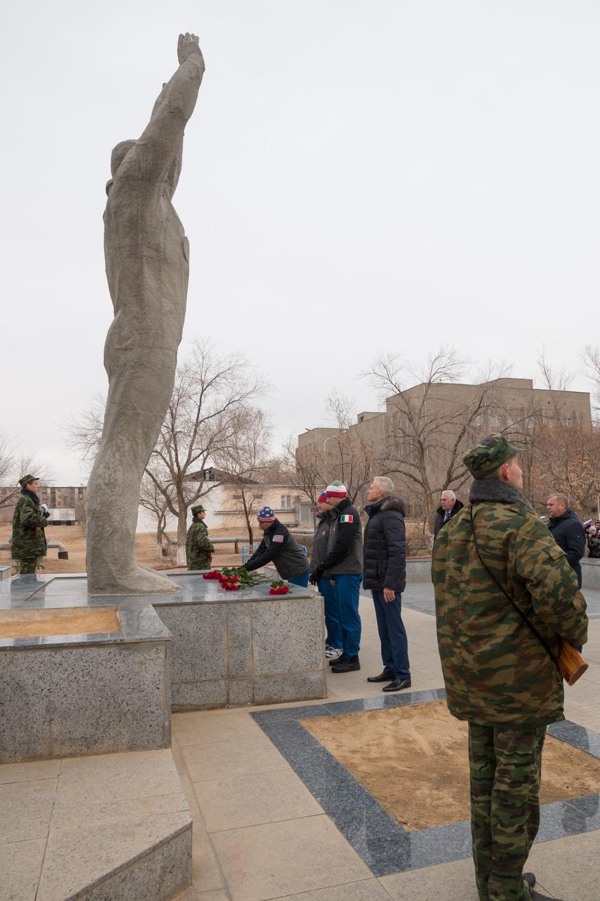 jsc2018e097315 - In the town of Baikonur, Kazakhstan, Expedition 58 backup crewmembers Drew Morgan of NASA, Alexander Skvortsov of Roscosmos and Luca Parmitano of the European Space Agency lay flowers at the statue of Yuri Gagarin, the first human to fly in space Nov. 21, in a traditional ceremony. They are the backups to Anne McClain of NASA, Oleg Kononenko of Roscosmos and David Saint-Jacques of the Canadian Space Agency, who will launch Dec. 3 on the Soyuz MS-11 spacecraft from the Baikonur Cosmodrome in Kazakhstan for a six-and-a-half month mission on the International Space Station...NASA/Victor Zelentsov.
