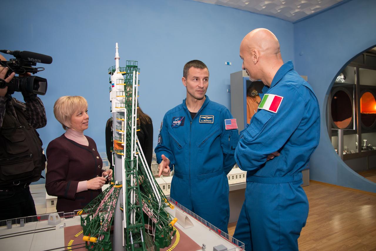 jsc2018e097319 - At the Baikonur Museum in the town of Baikonur, Kazakhstan, Expedition 58 backup crewmembers Drew Morgan of NASA (center) and Luca Parmitano of the European Space Agency (right) examine a model of a Soyuz rocket on the launch pad Nov. 21 in traditional pre-launch activities. They are backups to Anne McClain of NASA, Oleg Kononenko of Roscosmos and David Saint-Jacques of the Canadian Space Agency, who will launch Dec. 3 on the Soyuz MS-11 spacecraft from the Baikonur Cosmodrome in Kazakhstan for a six-and-a-half month mission on the International Space Station...NASA/Victor Zelentsov.