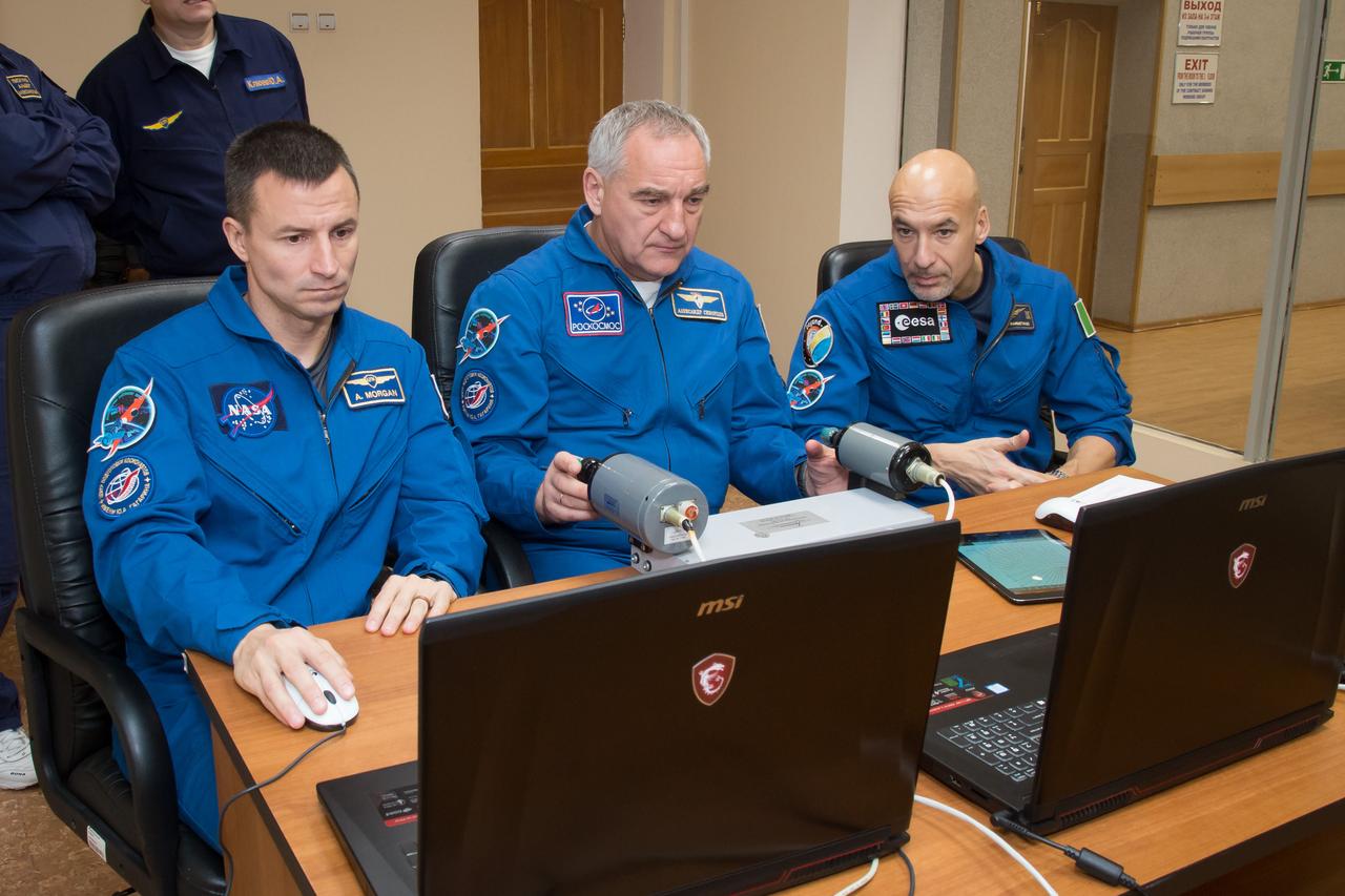 jsc2018e097767 - At their Cosmonaut Hotel crew quarters in Baikonur, Kazakhstan, Expedition 58 backup crewmembers Drew Morgan of NASA (left), Alexander Skvortsov of Roscosmos (center) and Luca Parmitano of the European Space Agency (right) rehearse rendezvous procedures on a laptop computer Nov. 27 as part of their pre-launch training. They are the backups to Anne McClain of NASA, Oleg Kononenko of Roscosmos and David Saint-Jacques of the Canadian Space Agency who will launch Dec. 3 on the Soyuz MS-11 spacecraft from the Baikonur Cosmodrome in Kazakhstan for a six-and-a-half month mission on the International Space Station...NASA/Victor Zelentsov.