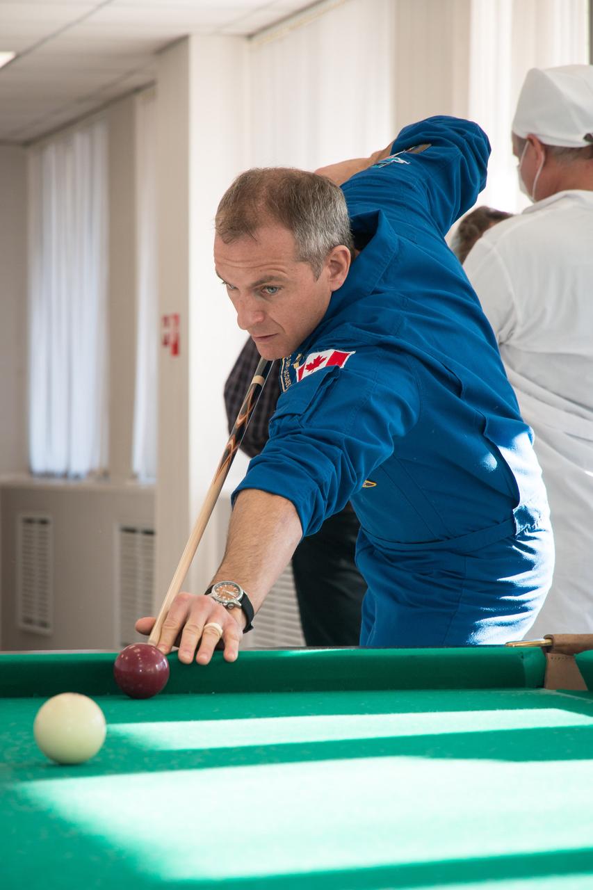 jsc2018e097768 - At his Cosmonaut Hotel crew quarters in Baikonur, Kazakhstan, Expedition 58 crewmember David Saint-Jacques of the Canadian Space Agency tries his hand at a game of billiards Nov. 27 during free time from pre-launch training. Saint-Jacques, Anne McClain of NASA and Oleg Kononenko of Roscosmos will launch Dec. 3 on the Soyuz MS-11 spacecraft from the Baikonur Cosmodrome in Kazakhstan for a six-and-a-half month mission on the International Space Station...NASA/Victor Zelentsov.