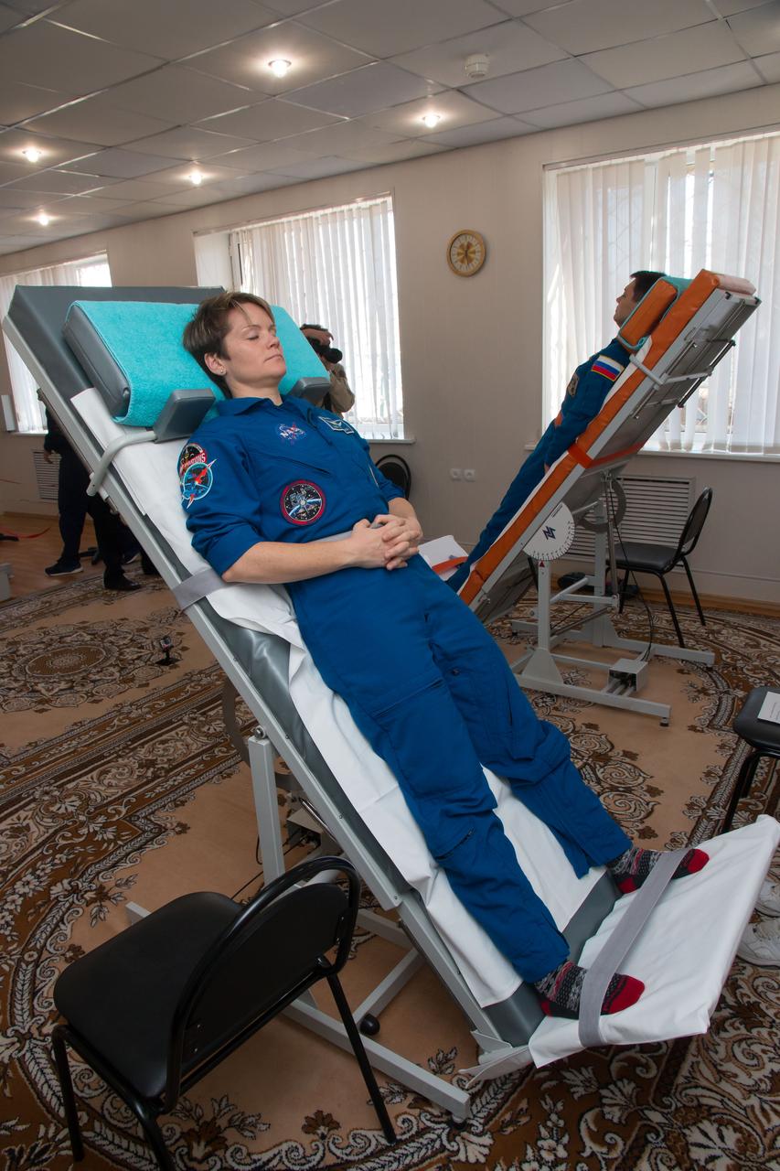 jsc2018e097773 - At the Cosmonaut Hotel crew quarters in Baikonur, Kazakhstan, Expedition 58 crewmember Anne McClain of NASA conducts vestibular system response training on a tilt table Nov. 27 as part of pre-launch training. McClain, David Saint-Jacques of the Canadian Space Agency and Oleg Kononenko of Roscosmos will launch Dec. 3 on the Soyuz MS-11 spacecraft from the Baikonur Cosmodrome in Kazakhstan for a six-and-a-half month mission on the International Space Station...NASA/Victor Zelentsov.