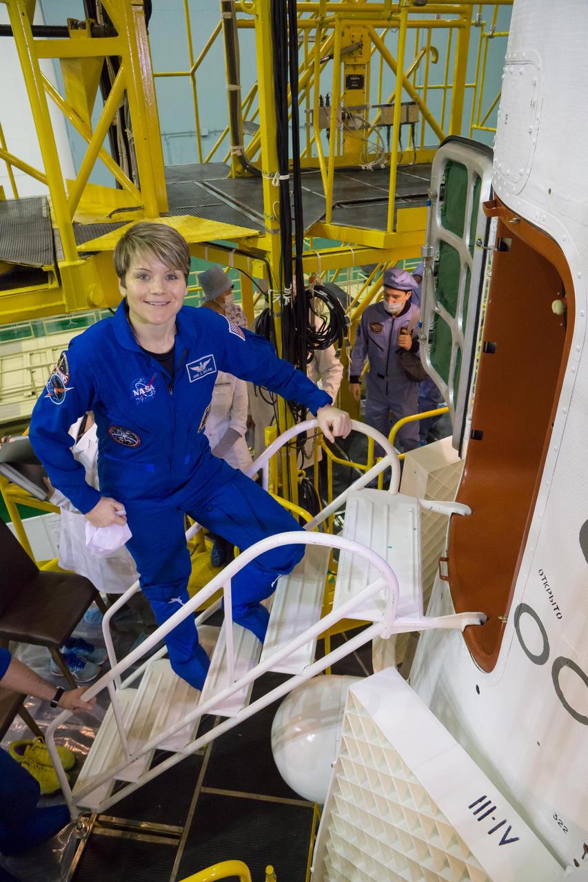 jsc2018e098090 - In the Integration Facility at the Baikonur Cosmodrome in Kazakhstan, Expedition 58 crewmember Anne McClain of NASA prepares to climb aboard the Soyuz MS-11 spacecraft Nov. 29 during a final vehicle fit check. McClain, Oleg Kononenko of Roscosmos and David Saint-Jacques of the Canadian Space Agency will launch Dec. 3 in the Soyuz MS-11 spacecraft from the Baikonur Cosmodrome in Kazakhstan for a six-and-a-half month mission on the International Space Station...NASA/Victor Zelentsov.
