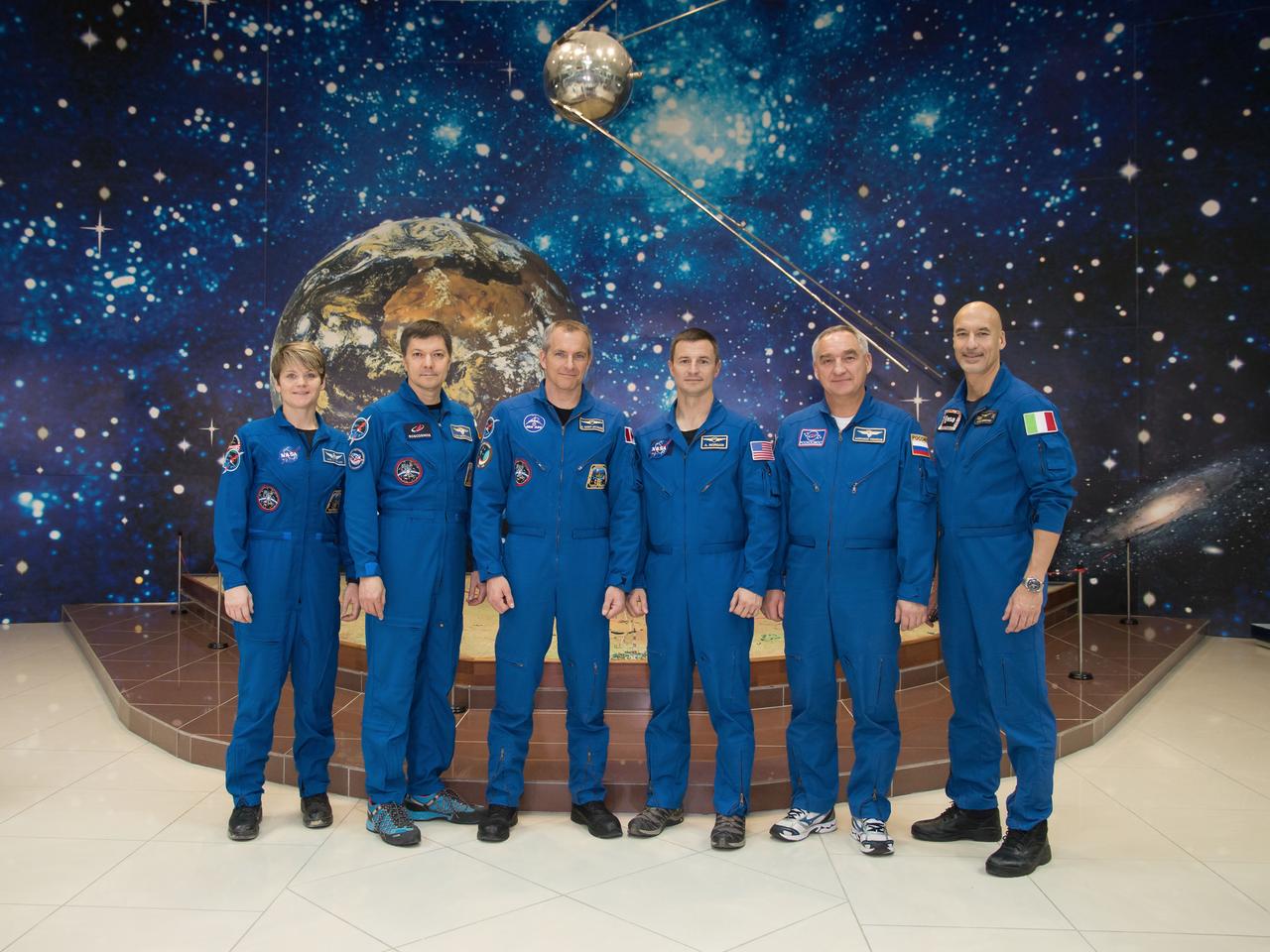 jsc2018e098097 - At the Baikonur Cosmodrome Museum in Kazakhstan, the Expedition 58 prime and backup crewmembers pose for pictures in front of a model of a Sputnik satellite Nov. 29 during a tour of the facility. From left to right are the prime crewmembers, Anne McClain of NASA, Oleg Kononenko of Roscosmos and David Saint-Jacques of the Canadian Space Agency and the backup crew, Drew Morgan of NASA, Alexander Skvortsov of Roscosmos and Luca Parmitano of the European Space Agency. McClain, Saint-Jacques and Kononenko will launch Dec. 3 in the Soyuz MS-11 spacecraft from the Baikonur Cosmodrome in Kazakhstan for a six-and-a-half month mission on the International Space Station...NASA/Victor Zelentsov.