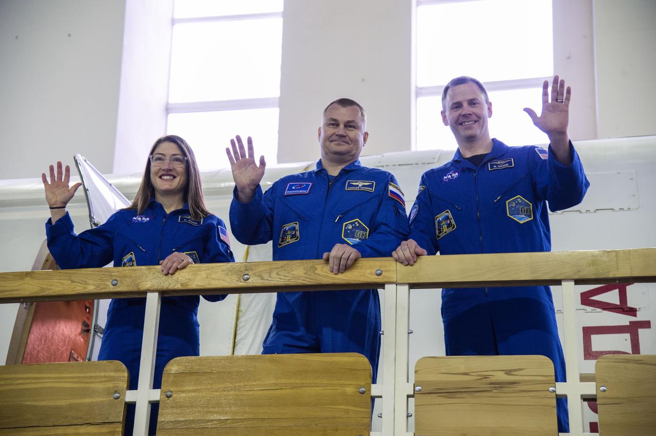 jsc2019e003765 (Feb. 19, 2019) --- At the Gagarin Cosmonaut Training Center in Star City, Russia, Expedition 59 crew members Christina Koch of NASA (left), Alexey Ovchinin of Roscosmos (center) and Nick Hague of NASA (right) wave to cameras Feb. 19 during the first of two days of final pre-launch qualification exams. They will launch March 14, U.S. time, from the Baikonur Cosmodrome in Kazakhstan on the Soyuz MS-12 spacecraft for a six-and-a-half month mission on the International Space Station. Credit: NASA/Beth Weissinger