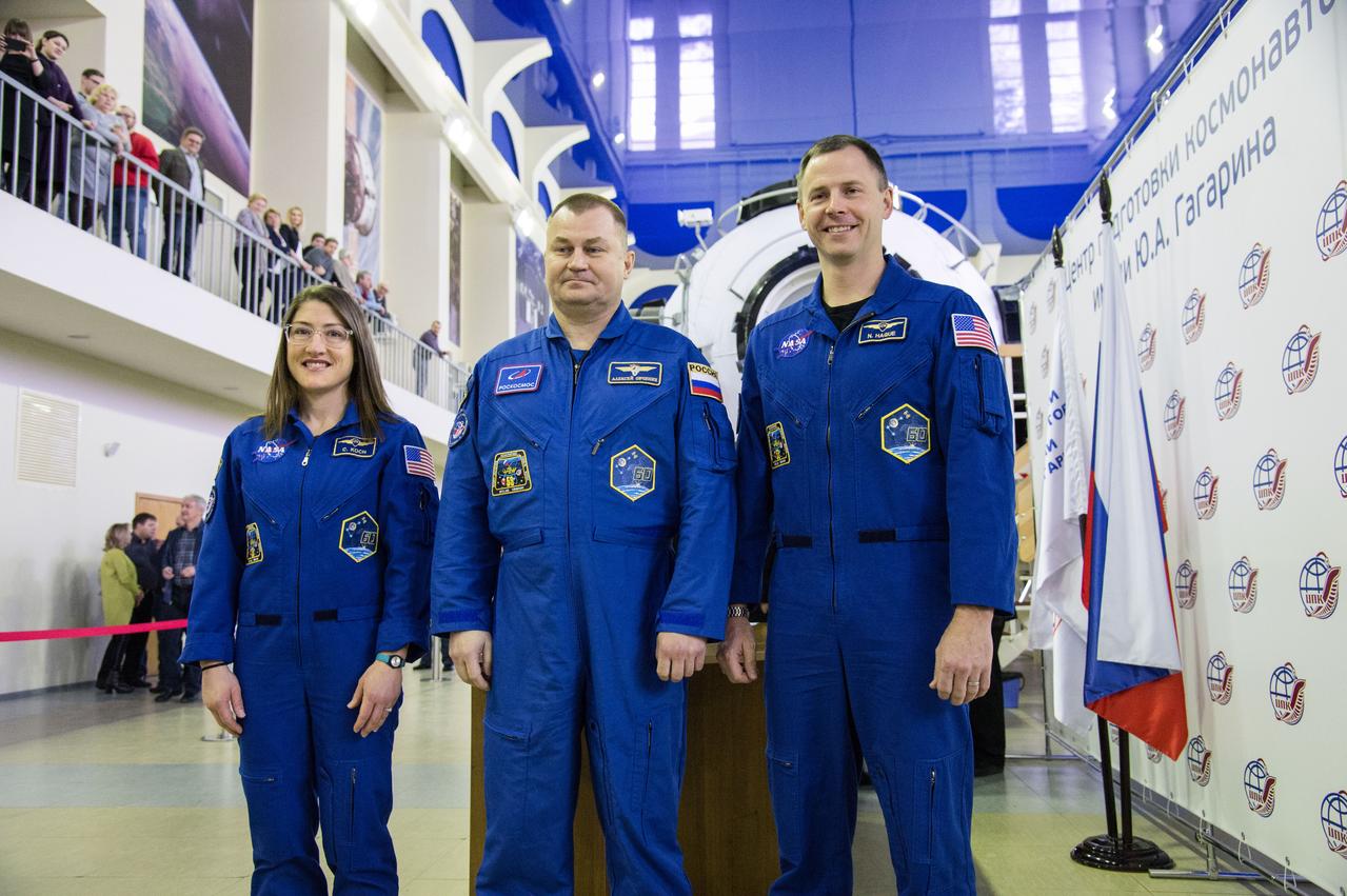 jsc2019e003768 (Feb. 19, 2019) --- At the Gagarin Cosmonaut Training Center in Star City, Russia, Expedition 59 crew members Christina Koch of NASA (left), Alexey Ovchinin of Roscosmos (center) and Nick Hague of NASA (right) pose for pictures Feb. 19 during the first of two days of final pre-launch qualification exams. They will launch March 14, U.S. time, from the Baikonur Cosmodrome in Kazakhstan on the Soyuz MS-12 spacecraft for a six-and-a-half month mission on the International Space Station. Credit: NASA/Beth Weissinger