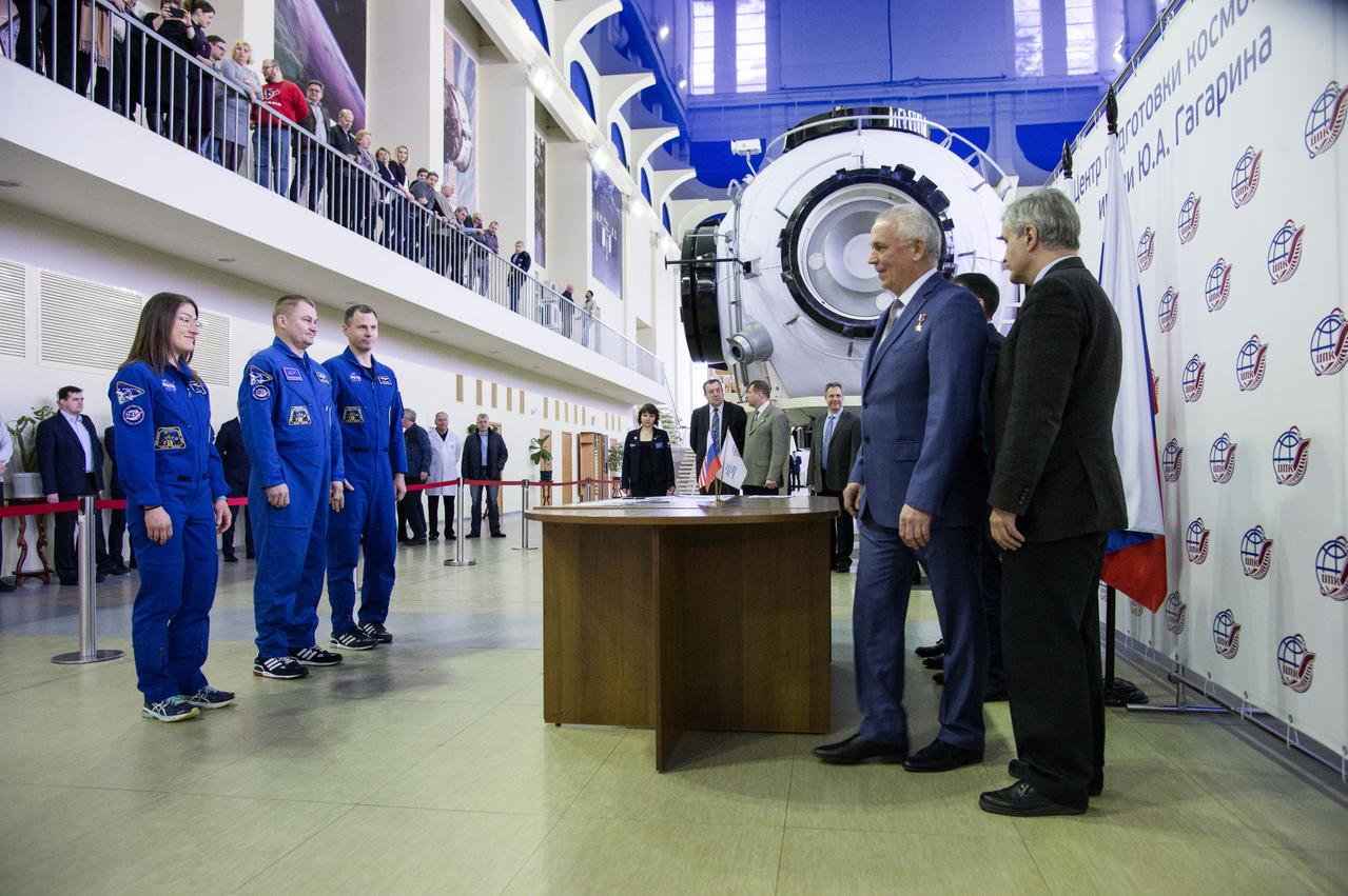 jsc2019e003770 (Feb. 19, 2019) --- At the Gagarin Cosmonaut Training Center in Star City, Russia, Expedition 59 crew members Christina Koch of NASA (left), Alexey Ovchinin of Roscosmos (center) and Nick Hague of NASA (right) report to Russian space officials Feb. 19 during the first of two days of final pre-launch qualification exams. They will launch March 14, U.S. time, from the Baikonur Cosmodrome in Kazakhstan on the Soyuz MS-12 spacecraft for a six-and-a-half month mission on the International Space Station. Credit: NASA/Beth Weissinger
