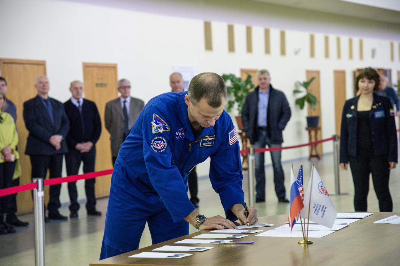 jsc2019e003774 (Feb. 19, 2019) --- At the Gagarin Cosmonaut Training Center in Star City, Russia, Expedition 59 crew member Nick Hague of NASA signs in for the start of two days of final pre-launch qualification exams Feb. 19. Hague, Christina Koch of NASA and Alexey Ovchinin of Roscosmos will launch March 14, U.S. time, from the Baikonur Cosmodrome in Kazakhstan on the Soyuz MS-12 spacecraft for a six-and-a-half month mission on the International Space Station. Credit: NASA/Beth Weissinger