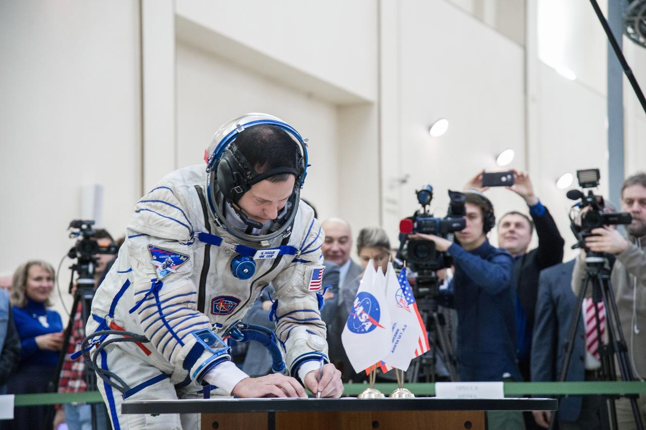 jsc2019e004064 (Feb. 20, 2019) --- At the Gagarin Cosmonaut Training Center in Star City, Russia, Expedition 59 crew member Nick Hague of NASA signs in for the second day of final pre-launch qualification exams Feb. 20. Hague, Christina Koch of NASA and Alexey Ovchinin of Roscosmos will launch March 14, U.S. time, in the Soyuz MS-12 spacecraft from the Baikonur Cosmodrome in Kazakhstan for a six-and-a-half month mission on the International Space Station. Credit: NASA/Beth Weissinger