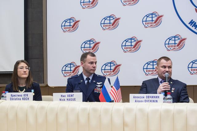 NASA image: jsc2019e004420 - At the Gagarin Cosmonaut Training Center in Star City, Russia, Expedition 59 crewmember Alexey Ovchinin of Roscosmos (right) responds to a reporterâ€™s question Feb. 21 during a pre-launch news conference as crewmates Christina Koch of NA