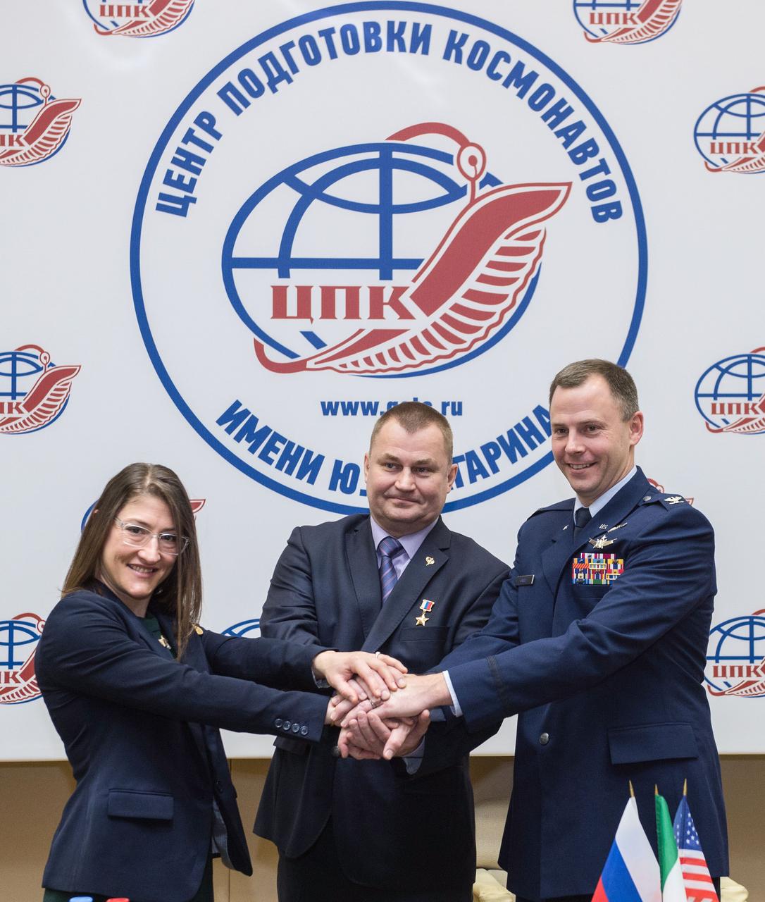 At the Gagarin Cosmonaut Training Center in Star City, Russia, Expedition 59 crewmembers Christina Koch of NASA (left), Alexey Ovchinin of Roscosmos (center) and Nick Hague of NASA (right) pose for pictures Feb. 21 following a pre-launch news conference. They will launch March 14, U.S. time, on the Soyuz MS-12 spacecraft from the Baikonur Cosmodrome in Kazakhstan for a six-and-a-half month mission on the International Space Station.  Andrey Shelepin/Gagarin Cosmonaut Training Center 