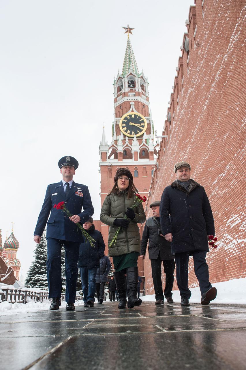 Expedition 59 crewmembers Nick Hague of NASA (left), Christina Koch of NASA (center) and Alexey Ovchinin of Roscosmos (right) walk along the Kremlin Wall in Moscow Feb. 21 as they prepare for the ceremonial laying of flowers as part of pre-launch activities. They will launch March 14, U.S. time, on the Soyuz MS-12 spacecraft from the Baikonur Cosmodrome in Kazakhstan for a six-and-a-half month mission on the International Space Station.  Andrey Shelepin/Gagarin Cosmonaut Training Center  