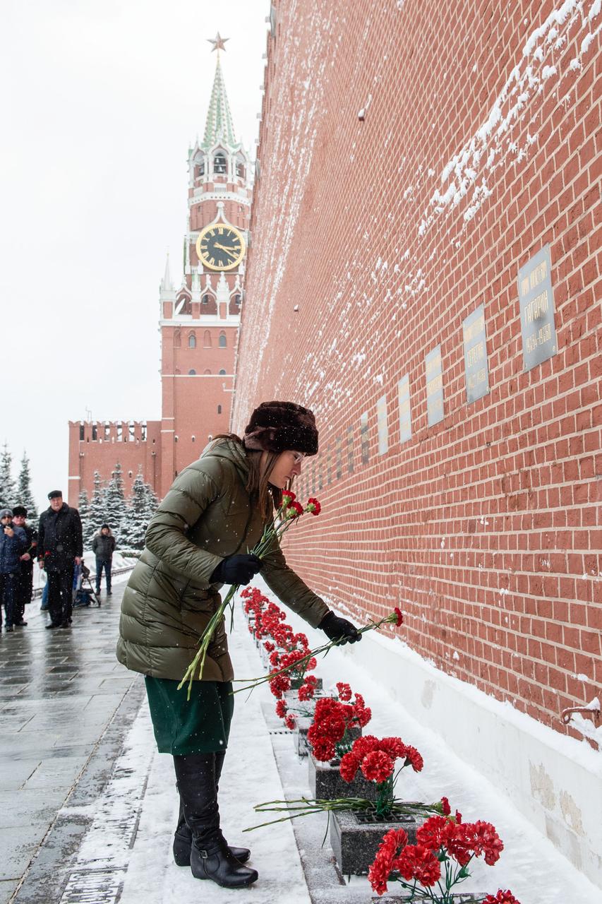 At the Kremlin Wall in Moscow, Expedition 59 crewmember Christina Koch of NASA lays flowers where Russian space icons are interred in traditional ceremonies Feb. 21. Koch, Nick Hague of NASA and Alexey Ovchinin of Roscosmos will launch March 14, U.S. time, on the Soyuz MS-12 spacecraft from the Baikonur Cosmodrome in Kazakhstan for a six-and-a-half month mission on the International Space Station.  Andrey Shelepin/Gagarin Cosmonaut Training Center 