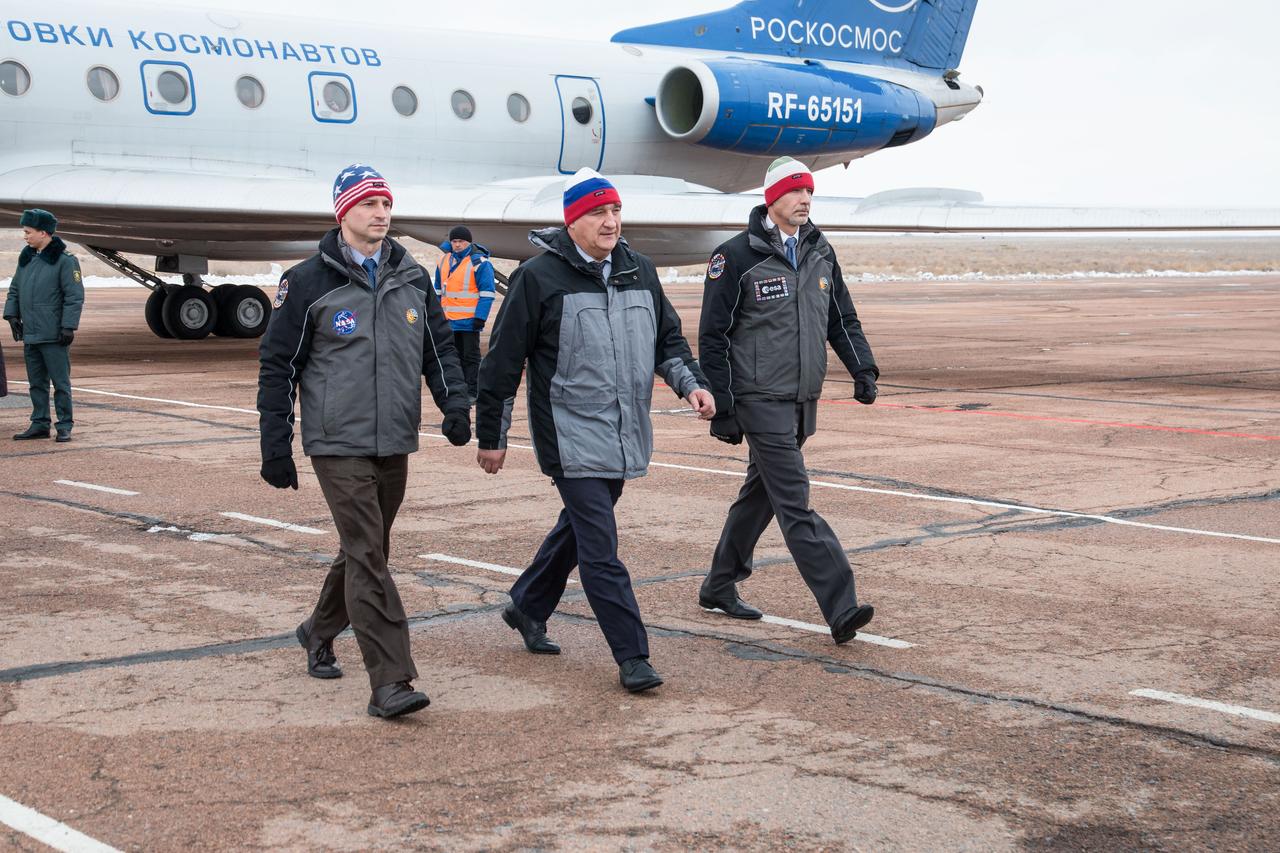 Expedition 59 backup crewmembers Drew Morgan of NASA (left), Alexander Skvortsov of Roscosmos (center) and Luca Parmitano of the European Space Agency (right) arrive at the Baikonur Cosmodrome in Kazakhstan Feb. 26 for final pre-launch training following a flight from their training base in Star City, Russia. They are the backups to the prime crew, Nick Hague of NASA, Christina Koch of NASA and Alexey Ovchinin of Roscosmos, who will launch March 14, U.S. time, on the Soyuz MS-12 spacecraft from the Baikonur Cosmodrome in Kazakhstan for a six-and-a-half month mission on the International Space Station.  NASA/Victor Zelentsov 