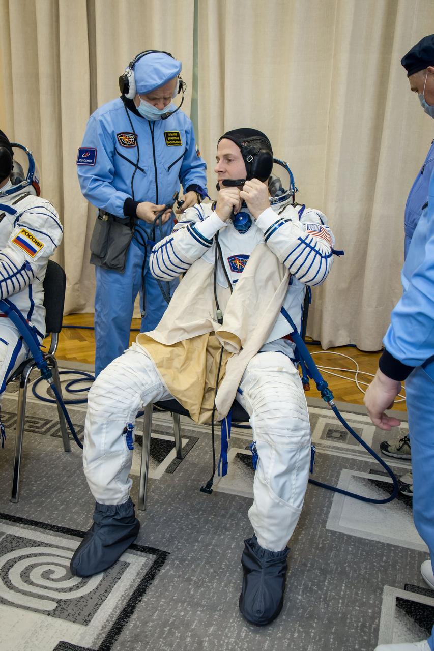 At the Baikonur Cosmodrome in Kazakhstan, Expedition 59 crewmember Nick Hague of NASA suits up for a Soyuz fit check dress rehearsal Feb. 27 during pre-launch training. Hague, Christina Koch of NASA and Alexey Ovchinin of Roscosmos will launch March 14, U.S. time, on the Soyuz MS-12 spacecraft from the Baikonur Cosmodrome in Kazakhstan for a six-and-a-half month mission on the International Space Station. NASA/Victor Zelentsov