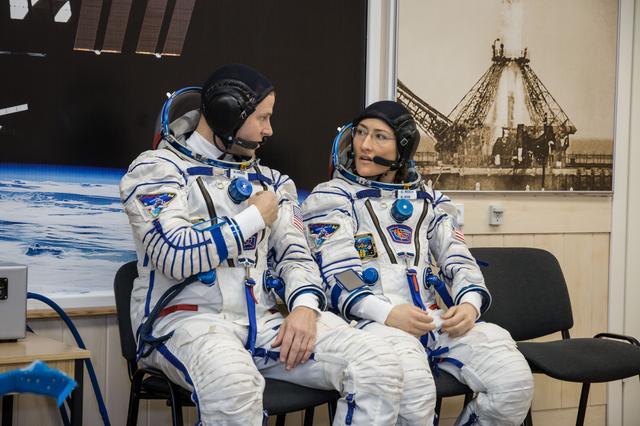 NASA image: jsc2019e009948 - At the Baikonur Cosmodrome in Kazakhstan, Expedition 59 crewmembers Nick Hague (left) and Christina Koch (right) of NASA discuss procedures Feb. 27 during a Soyuz fit check dress rehearsal that is part of pre-launch training. Hague, Koch 