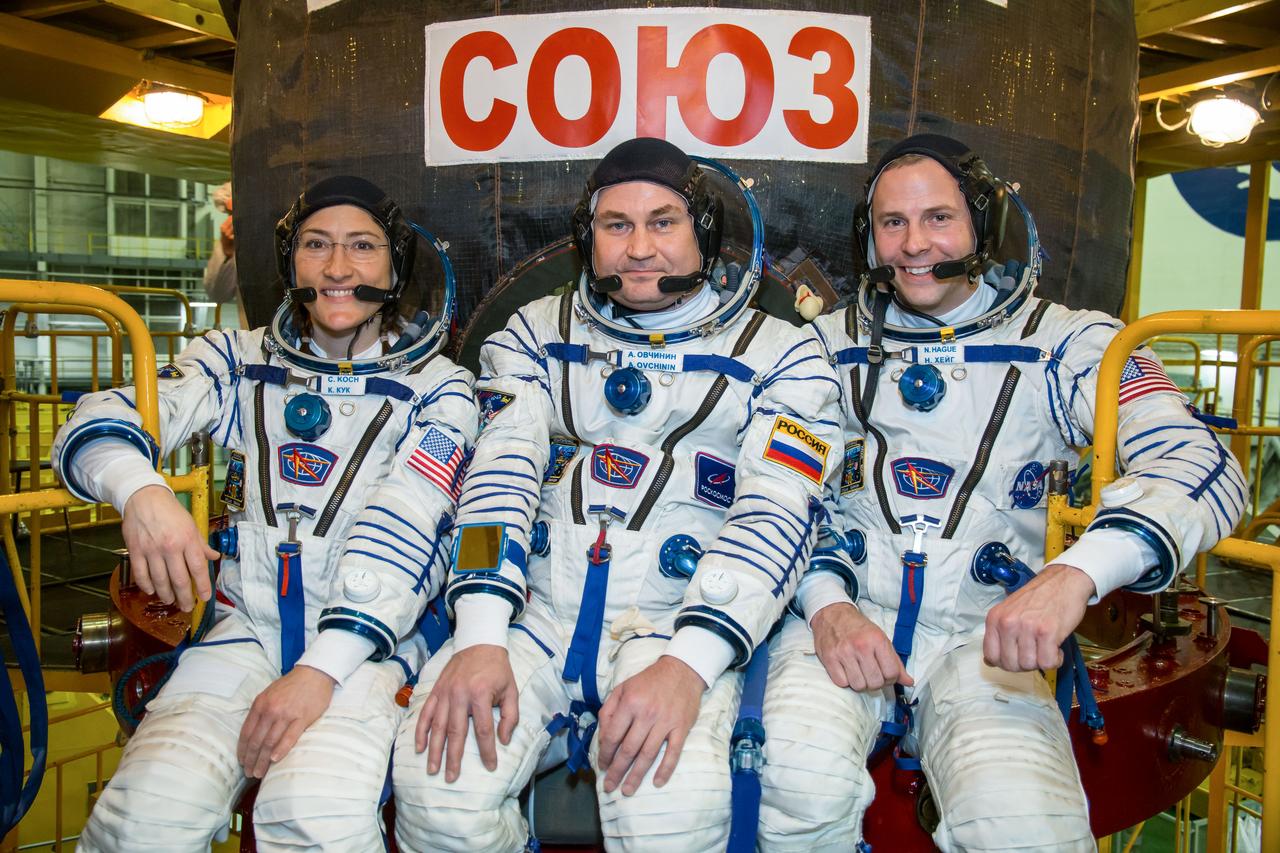 At the Baikonur Cosmodrome in Kazakhstan, Expedition 59 crewmembers Christina Koch of NASA (left), Alexey Ovchinin of Roscosmos (center) and Nick Hague of NASA (right) pose for pictures in front of their Soyuz MS-12 spacecraft Feb. 27 during pre-launch training. They will launch March 14, U.S. time, on the Soyuz MS-12 spacecraft from the Baikonur Cosmodrome in Kazakhstan for a six-and-a-half month mission on the International Space Station. NASA/Victor Zelentsov