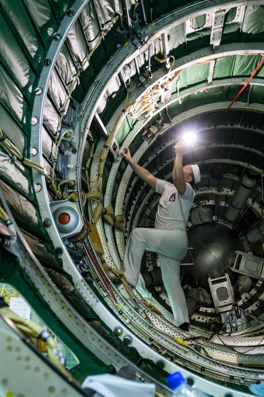In the Integration Building at the Baikonur Cosmodrome in Kazakhstan, a technician inspects the interior of the nose fairing of the Soyuz booster March 6 that the Soyuz MS-12 spacecraft will be encapsulated in for launch on March 14, U.S. time. Expedition 59 crewmembers Nick Hague and Christina Koch of NASA and Alexey Ovchinin of Roscosmos will launch on March 14, U.S. time, on the Soyuz MS-12 spacecraft from the Baikonur Cosmodrome for a six-and-a-half month mission on the International Space Station...NASA/Victor Zelentsov.