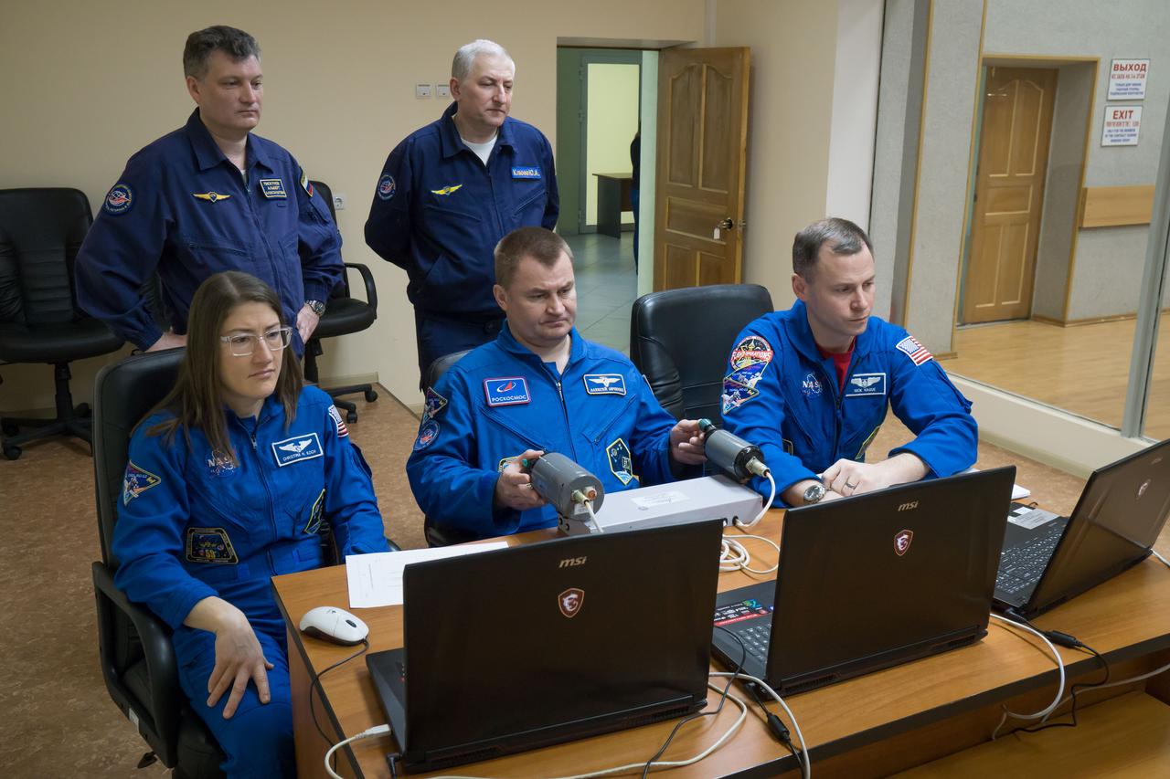 At their Cosmonaut Hotel crew quarters in Baikonur, Kazakhstan, Expedition 59 crewmembers Christina Koch of NASA (left), Alexey Ovchinin of Roscosmos (center) and Nick Hague of NASA (right) rehearse rendezvous and docking techniques on a laptop computer simulator March 7 as they prepare for launch. They will launch March 14, U.S. time, on the Soyuz MS-12 spacecraft from the Baikonur Cosmodrome for a six-and-a-half month mission on the International Space Station...NASA/Victor Zelentsov.
