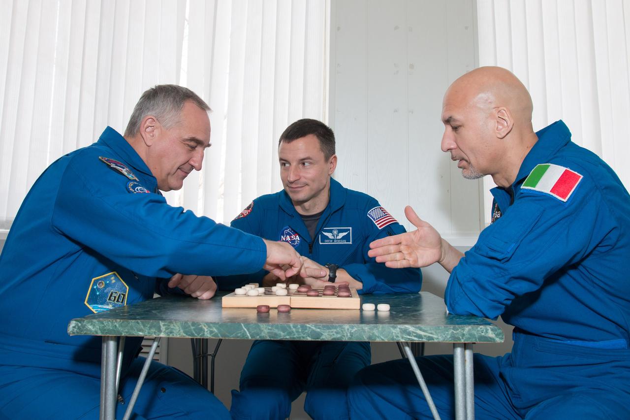 At their Cosmonaut Hotel crew quarters in Baikonur, Kazakhstan, Expedition 59 backup crewmembers Alexander Skvortsov of Roscosmos (left), Drew Morgan of NASA (center) and Luca Parmitano of the European Space Agency (right) take a moment from pre-launch training for a game of chess March 7. They are the backups to the prime crewmembers, Christina Koch of NASA, Alexey Ovchinin of Roscosmos and Nick Hague of NASA, who will launch March 14, U.S. time, on the Soyuz MS-12 spacecraft from the Baikonur Cosmodrome for a six-and-a-half month mission on the International Space Station...NASA/Victor Zelentsov.