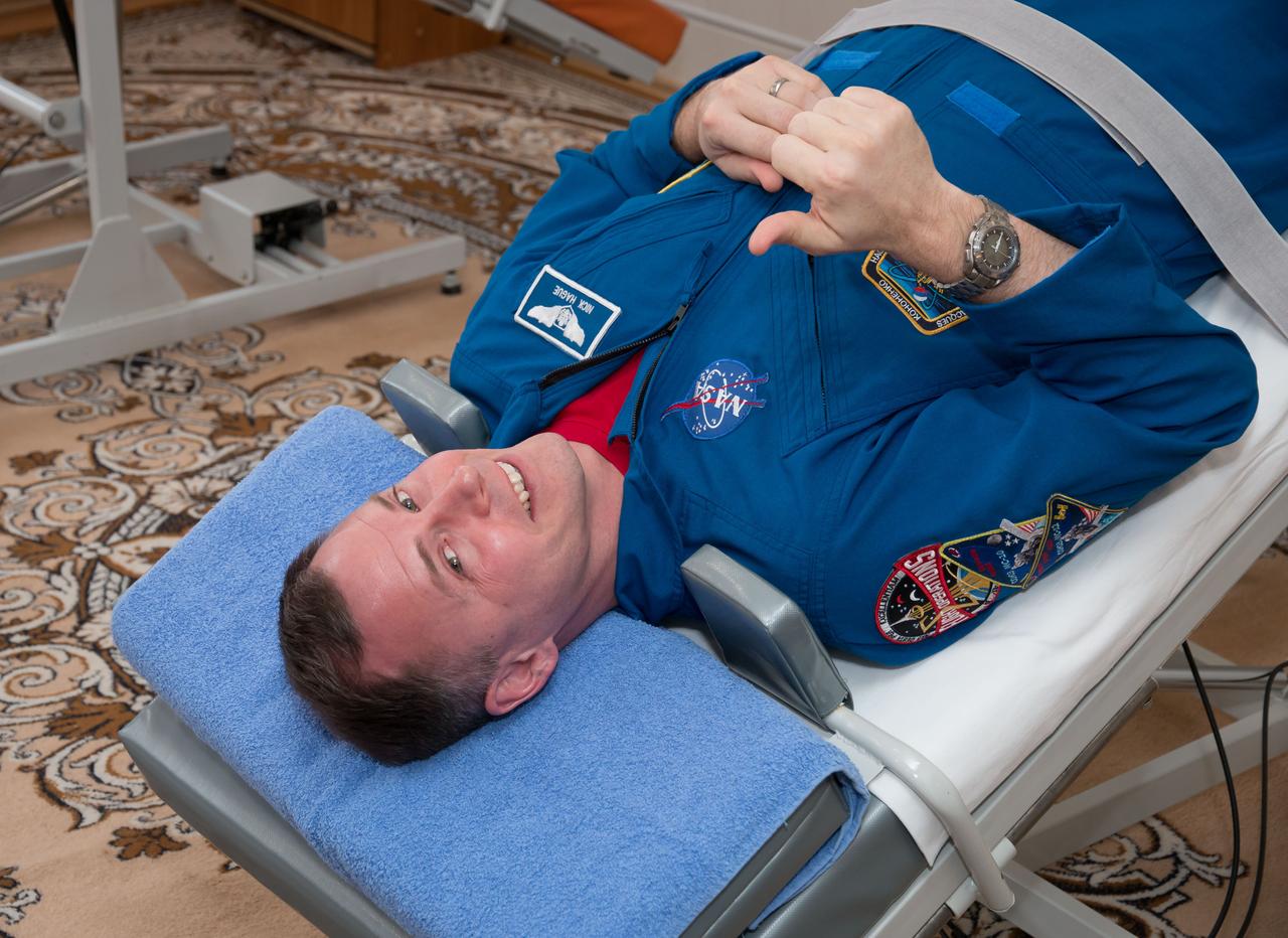 At the Cosmonaut Hotel crew quarters in Baikonur, Kazakhstan, Expedition 59 crewmember Nick Hague of NASA flashes a thumbs-up signal as he tests his vestibular system on a tilt table March 7 as part of his pre-launch activities. Hague, Christina Koch of NASA and Alexey Ovchinin of Roscosmos will launch March 14, U.S. time, on the Soyuz MS-12 spacecraft from the Baikonur Cosmodrome for a six-and-a-half month mission on the International Space Station...NASA/Victor Zelentsov.