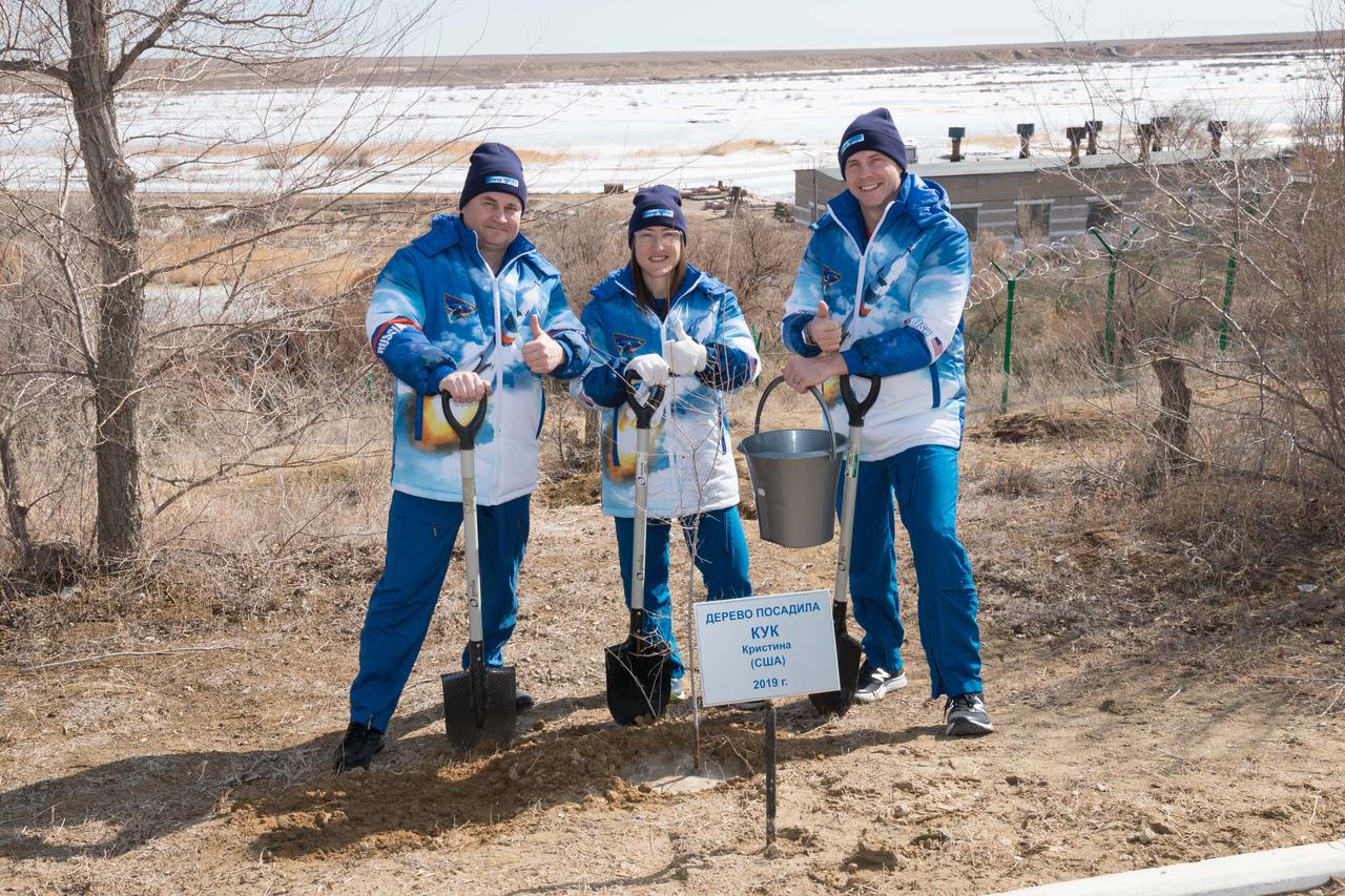 At the Cosmonaut Hotel crew quarters in Baikonur, Kazakhstan, Expedition 59 crewmembers Alexey Ovchinin of Roscosmos (left), Christina Koch of NASA (center) and Nick Hague of NASA (right) pose for pictures March 7 after Koch planted a tree in her name in traditional pre-launch activities. They will launch March 14, U.S. time, on the Soyuz MS-12 spacecraft from the Baikonur Cosmodrome for a six-and-a-half month mission on the International Space Station...NASA/Victor Zelentsov.
