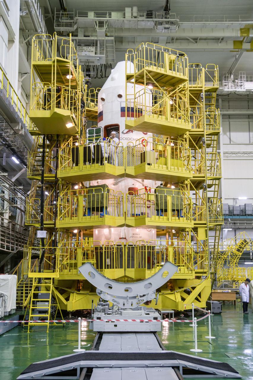 jsc2019e013409 - In the Integration Building at the Baikonur Cosmodrome in Kazakhstan, the Soyuz MS-12 spacecraft is surrounded by scaffolding March 10 as technicians conduct final pre-launch inspections. Expedition 59 crewmembers Nick Hague and Christina Koch of NASA and Alexey Ovchinin of Roscosmos will launch March 14, U.S. time, in the Soyuz MS-12 spacecraft from the Baikonur Cosmodrome for a six-and-a-half month mission on the International Space Station...NASA/Victor Zelentsov.