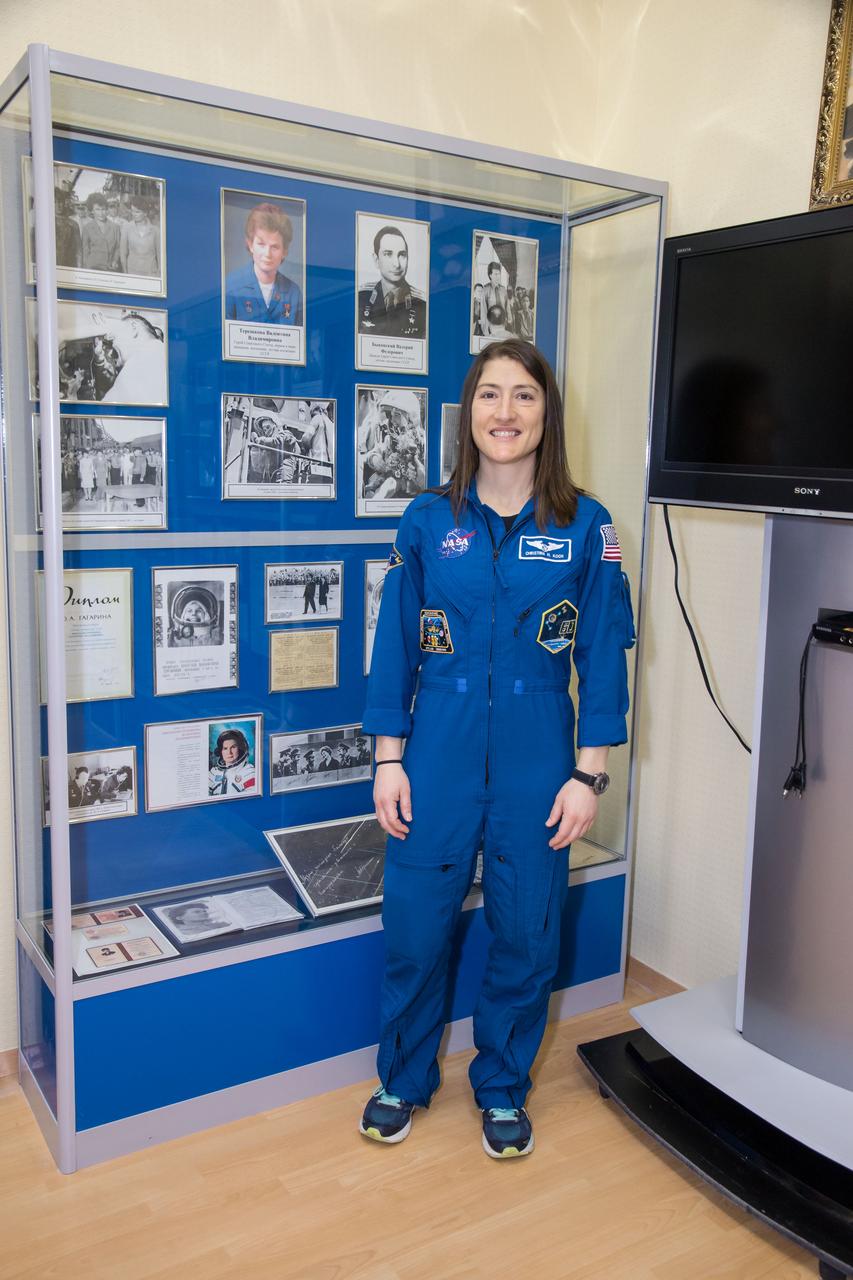 jsc2019e013422 - At the Baikonur Cosmodrome in Kazakhstan, Expedition 59 crewmember Christina Koch of NASA poses for pictures March 10 in front of a display housing memorabilia from the flight of the first woman to fly in space, Valentina Tereshkova, whose historic mission took place in June 1963. Koch, Nick Hague of NASA and Alexey Ovchinin of Roscosmos will launch March 14, U.S. time, in the Soyuz MS-12 spacecraft from the Baikonur Cosmodrome for a six-and-a-half month mission on the International Space Station...NASA/Victor Zelentsov.