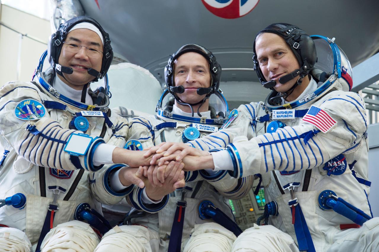 jsc2019e035256 - At the Gagarin Cosmonaut Training Center in Star City, Russia, Expedition 60 backup crewmembers Soichi Noguchi of the Japan Aerospace Exploration Agency (left), Sergey Ryzhikov of Roscosmos (center) and Tom Marshburn of NASA (right) pose for pictures June 26 during their final qualification exams. They are the backups to the prime crew, Alexander Skvortsov of Roscosmos, Drew Morgan of NASA and Luca Parmitano of the European Space Agency, who will launch July 20 on the Soyuz MS-13 spacecraft from the Baikonur Cosmodrome in Kazakhstan for a mission on the International Space Station...NASA/Beth Weissinger.