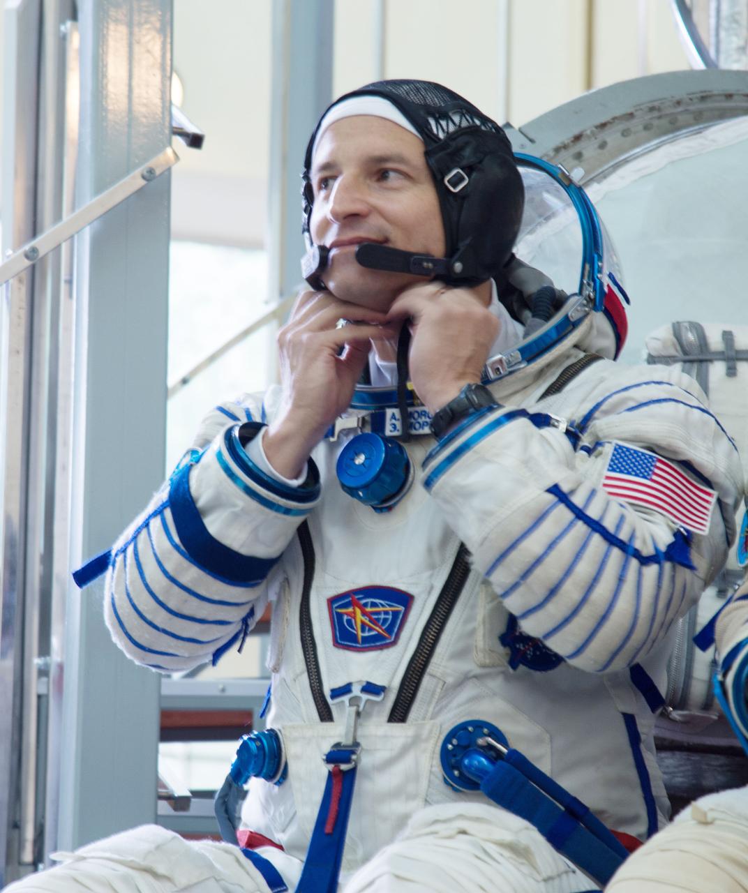 jsc2019e035393 - At the Gagarin Cosmonaut Training Center in Star City, Russia, Expedition 60 crewmember Drew Morgan of NASA adjusts his helmet June 27 as he listens to a reporter’s question during the final day of qualification exams. Morgan, Alexander Skvortsov of Roscosmos and Luca Parmitano of the European Space Agency will launch on July 20 from the Baikonur Cosmodrome in Kazakhstan on the Soyuz MS-13 spacecraft for a mission to the International Space Station...NASA/Beth Weissinger.