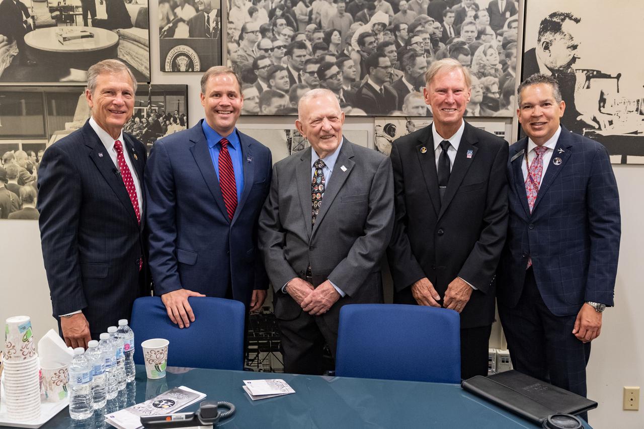 jsc2019e036671 (June 28, 2019) – Apollo 11 flight director Gene Kranz is surrounded by grand opening participants (from left) U.S. Rep. Brian Babin, NASA Administrator Jim Bridenstine, Kranz, Advisory Council on Historic Preservation’s  Chairman Milford Wayne Donaldson and Space Center Houston CEO William Harris in the visitors in NASA Johnson Space Center’s Teague Auditlorium. NASA’s Johnson Space Center reopened the fully restored Apollo Mission Control Center with a grand opening and ribbon cutting event with NASA Administrator Jim Bridenstine on June 28. The room now is reconfigured to its Apollo-era condition. Many of the items in the restored room are original pieces from 1969 that were found or donated, and the missing items were replicated to ensure walking into the viewing room would feel like taking a step back in time. The restoration team used old photographs, footage, documents and interviews and discussions with Apollo veterans to set everything in its proper place, including coffee mugs, clothing articles and ashtrays. Beginning July 1, the Apollo Mission Control Center will become part of daily tours at Johnson hosted by Space Center Houston.