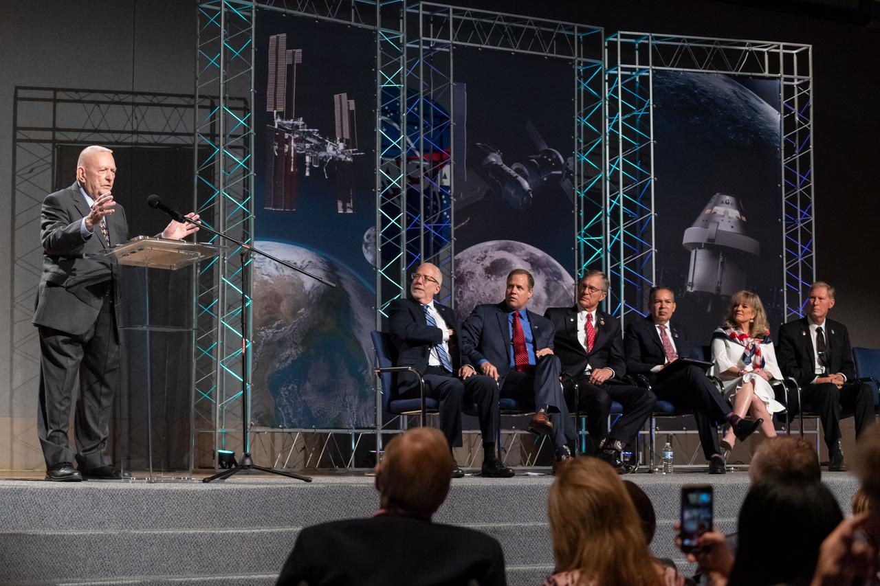 jsc2019e036696 (June 28, 2019) – Apollo 11 flight director Gene Kranz talks to grand opening visitors in NASA Johnson Space Center’s Teague Auditorium. NASA’s Johnson Space Center reopened the fully restored Apollo Mission Control Center with a grand opening and ribbon cutting event with NASA Administrator Jim Bridenstine on June 28. The room now is reconfigured to its Apollo-era condition. Many of the items in the restored room are original pieces from 1969 that were found or donated, and the missing items were replicated to ensure walking into the viewing room would feel like taking a step back in time. The restoration team used old photographs, footage, documents and interviews and discussions with Apollo veterans to set everything in its proper place, including coffee mugs, clothing articles and ashtrays. Beginning July 1, the Apollo Mission Control Center will become part of daily tours at Johnson hosted by Space Center Houston.