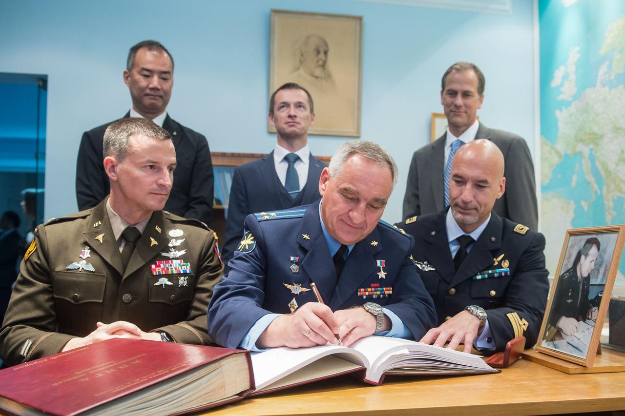 jsc2019e036800 - At the Gagarin Cosmonaut Training Center in Star City, Russia, Expedition 60 crewmember Alexander Skvortsov of Roscosmos (front row, middle) signs a ceremonial book June 28 during pre-launch activities. Looking on are prime crewmates Drew Morgan of NASA (left) and Luca Parmitano of the European Space Agency (right). In the back row from left to right are the backup crewmembers, Soichi Noguchi of the Japan Aerospace Exploration Agency, Sergey Ryzhikov of Roscosmos and Tom Marshburn of NASA. Morgan, Parmitano and Skvortsov will launch July 20 on the Soyuz MS-13 spacecraft from the Baikonur Cosmodrome in Kazakhstan for a mission on the International Space Station...Andrey Shelepin/GCTC.