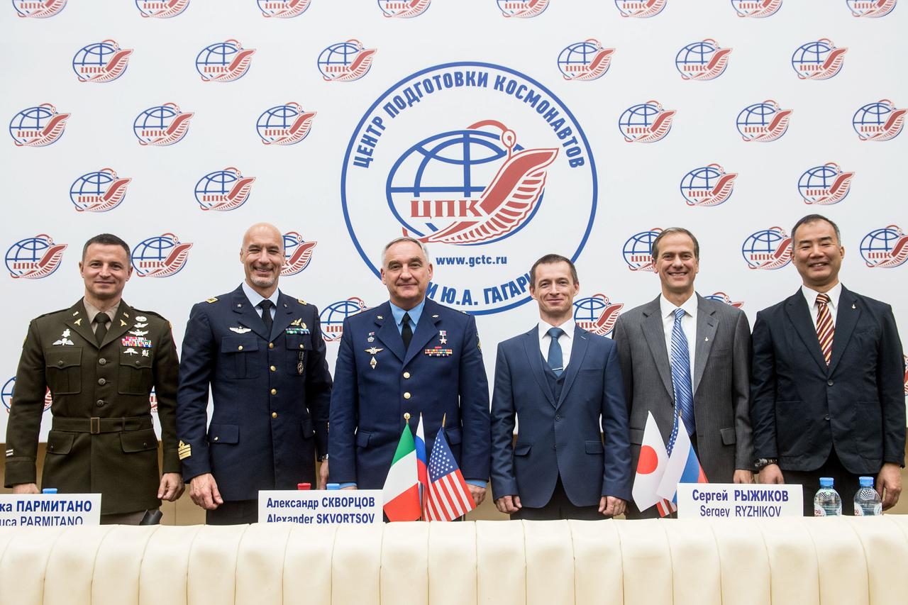 jsc2019e036805 - At the Gagarin Cosmonaut Training Center in Star City, Russia, the Expedition 60 prime and backup crewmembers pose for pictures during a news conference June 28. From left to right are prime crewmembers Drew Morgan of NASA, Luca Parmitano of the European Space Agency and Alexander Skvortsov of Roscosmos and the backup crew, Sergey Ryzhikov of Roscosmos, Tom Marshburn of NASA and Soichi Noguchi of the Japan Aerospace Exploration Agency. Morgan, Parmitano and Skvortsov will launch July 20 on the Soyuz MS-13 spacecraft from the Baikonur Cosmodrome in Kazakhstan for a mission on the International Space Station...Andrey Shelepin/GCTC.