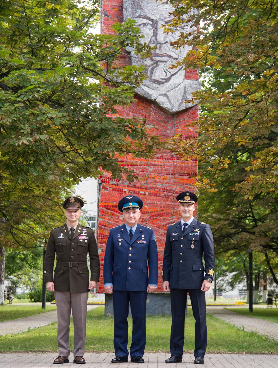 jsc2019e038375 - At the Gagarin Cosmonaut Training Center in Star City, Russia, the mural of Vladimir Lenin serves as a backdrop as Expedition 60 crewmembers Drew Morgan of NASA (left), Alexander Skvortsov of Roscosmos (center) and Luca Parmitano of the European Space Agency (right) pose for pictures July 4 before departing for their launch site in Kazakhstan. They will launch July 20 from the Baikonur Cosmodrome in Kazakhstan on the Soyuz MS-13 spacecraft for a mission on the International Space Station...NASA/Beth Weissinger.