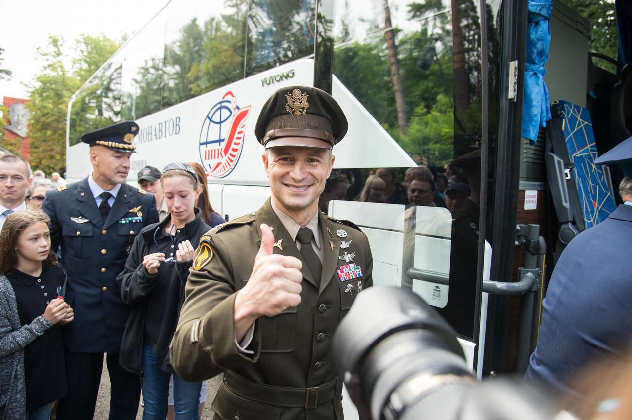 jsc2019e038377 - At the Gagarin Cosmonaut Training Center in Star City, Russia, Expedition 60 crewmember Drew Morgan of NASA flashes a thumbs up as he boards a bus July 4 before departing on a flight for his launch site in Kazakhstan. In the background is crewmate Luca Parmitano of the European Space Agency. Morgan, Parmitano and Alexander Skvortsov of Roscosmos will launch July 20 from the Baikonur Cosmodrome in Kazakhstan on the Soyuz MS-13 spacecraft for a mission on the International Space Station...NASA/Beth Weissinger..
