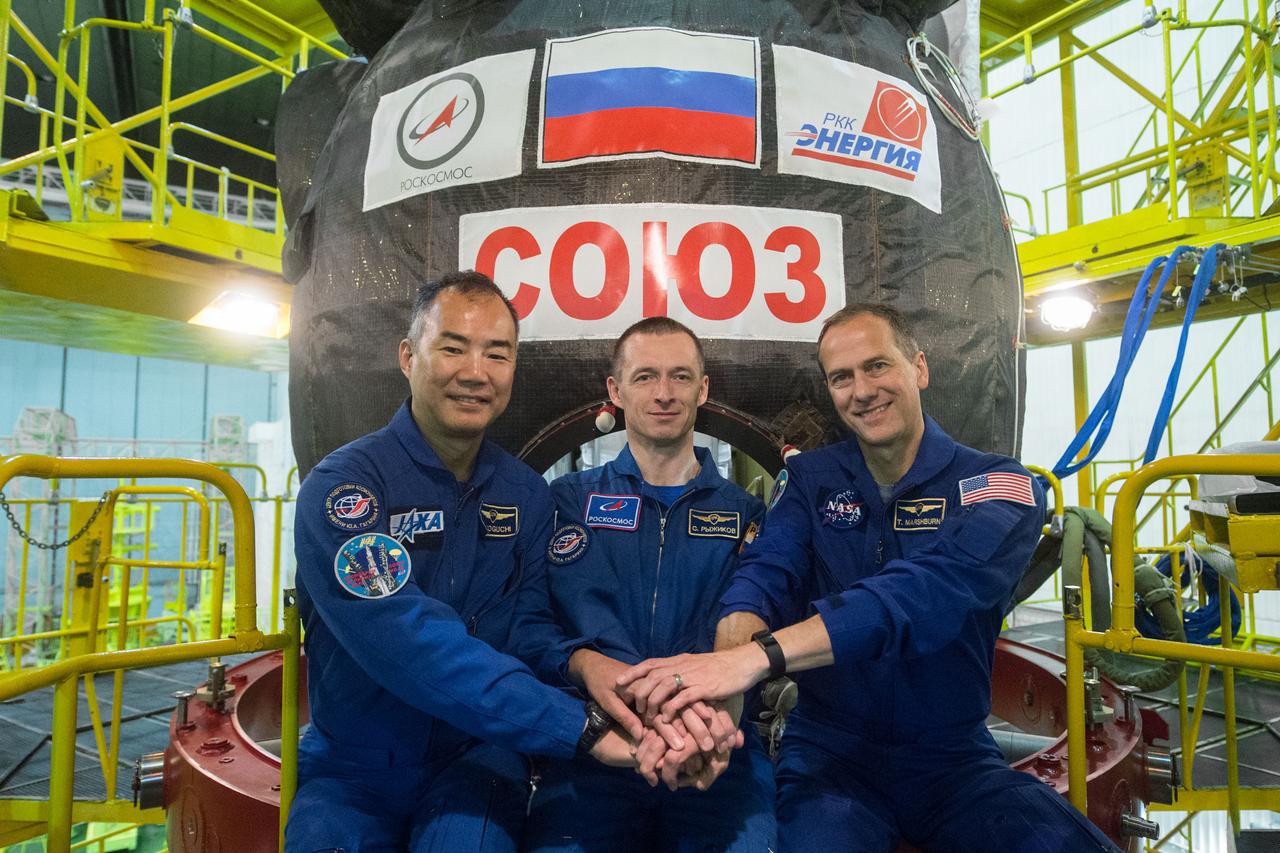 jsc2019e038388 - At the Baikonur Cosmodrome in Kazakhstan, Expedition 60 backup crwewmembers Soichi Noguchi of the Japan Aerospace Exploration Agency (left), Sergey Ryzhikov of Roscosmos (center) and Tom Marshburn of NASA (right) pose for pictures July 5 in front of the Soyuz MS-13 spacecraft during pre-launch preparations. They are the backups to Drew Morgan of NASA, Alexander Skvortsov of Roscosmos and Luca Parmitano of the European Space Agency, who will launch July 20 on the Soyuz MS-13 spacecraft from the Baikonur Cosmodrome for a mission on the International Space Station...Andrey Shelepin/GCTC.