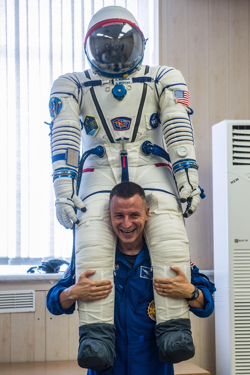 jsc2019e038389 - At the Baikonur Cosmodrome in Kazakhstan, Expedition 60 crewmember Drew Morgan of NASA poses with his Sokol launch and entry suit July 5 as part of pre-launch preparations. Morgan, Luca Parmitano of the European Space Agency and Alexander Skvortsov of Roscosmos will launch July 20 on the Soyuz MS-13 spacecraft from the Baikonur Cosmodrome for a mission on the International Space Station...Andrey Shelepin/GCTC.