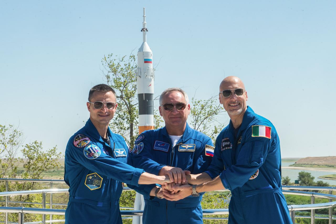 jsc2019e039260 - At the Cosmonaut Hotel crew quarters in Baikonur, Kazakhstan, Expedition 60 crewmembers Drew Morgan of NASA (left), Alexander Skvortsov of Roscosmos (center) and Luca Parmitano of the European Space Agency (right) pose for pictures July 12 as part of pre-launch activities. They will launch July 20 on the Soyuz MS-13 spacecraft from the Baikonur Cosmodrome in Kazakhstan on a mission to the International Space Station...Andrey Shelepin/GCTC.