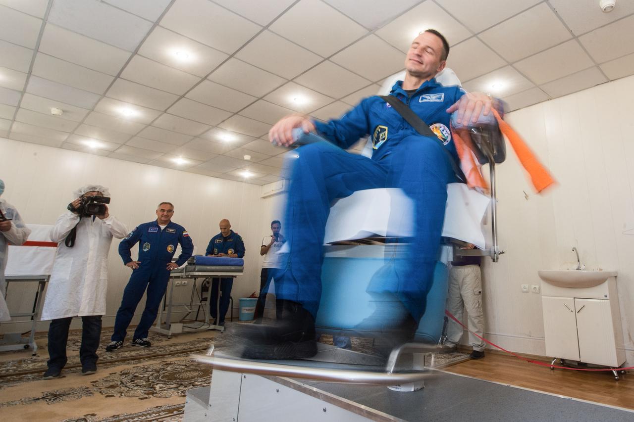 jsc2019e039262 - At the Cosmonaut Hotel crew quarters in Baikonur, Kazakhstan, Expedition 60 crewmember Drew Morgan of NASA takes a ride in a spinning chair July 12 to test his vestibular system as part of pre-launch activities. Morgan, Alexander Skvortsov of Roscosmos and Luca Parmitano of the European Space Agency will launch July 20 on the Soyuz MS-13 spacecraft from the Baikonur Cosmodrome in Kazakhstan on a mission to the International Space Station...Andrey Shelepin/GCTC.