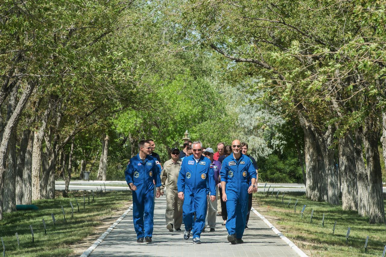 jsc2019e039263 - At the Cosmonaut Hotel crew quarters in Baikonur, Kazakhstan, Expedition 60 crewmembers Drew Morgan of NASA (left), Alexander Skvortsov of Roscosmos (center) and Luca Parmitano of the European Space Agency (right) stroll down the Walk of the Cosmonauts July 12 as part of pre-launch activities. They will launch July 20 on the Soyuz MS-13 spacecraft from the Baikonur Cosmodrome in Kazakhstan on a mission to the International Space Station...Andrey Shelepin/GCTC.