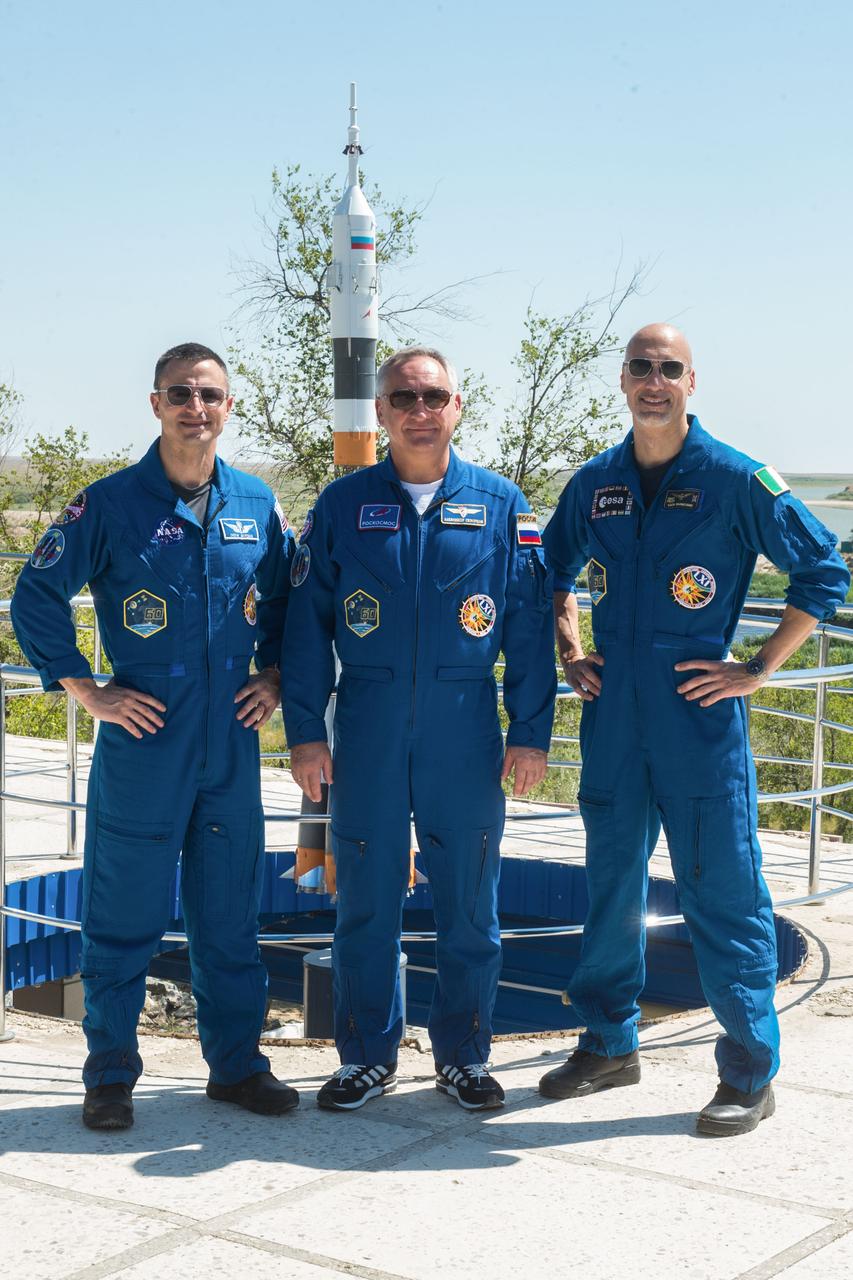 jsc2019e039269 - At the Cosmonaut Hotel crew quarters in Baikonur, Kazakhstan, Expedition 60 crewmembers Drew Morgan of NASA (left), Alexander Skvortsov of Roscosmos (center) and Luca Parmitano of the European Space Agency (right) pose for pictures July 12 as part of pre-launch activities. They will launch July 20 on the Soyuz MS-13 spacecraft from the Baikonur Cosmodrome in Kazakhstan on a mission to the International Space Station...Andrey Shelepin/GCTC.