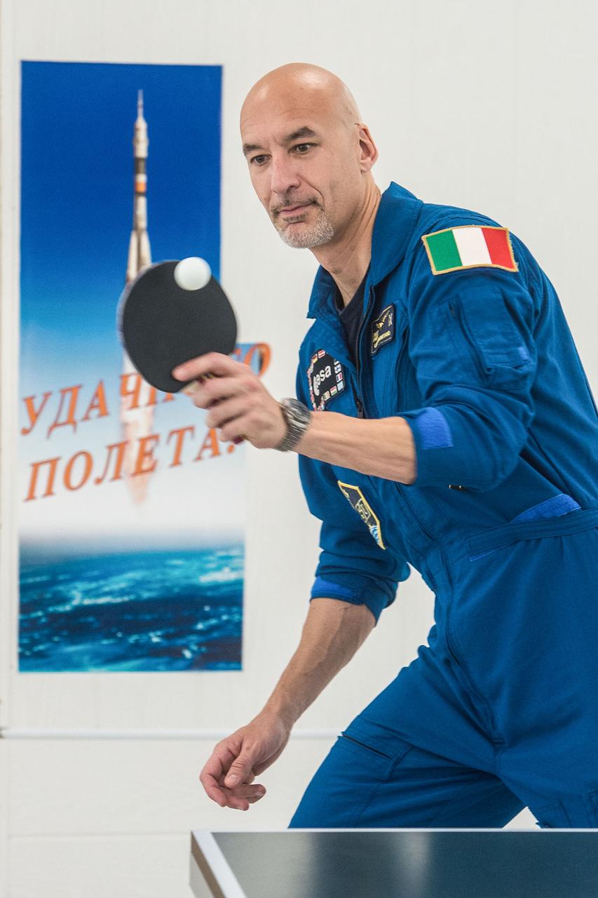 jsc2019e039271 - At the Cosmonaut Hotel crew quarters in Baikonur, Kazakhstan, Expedition 60 crewmember Luca Parmitano of the European Space Agency tries his hand at a game of ping-pong July 12 as part of pre-launch activities. Parmitano, Drew Morgan of NASA and Alexander Skvortsov of Roscosmos will launch July 20 on the Soyuz MS-13 spacecraft from the Baikonur Cosmodrome in Kazakhstan on a mission to the International Space Station...Andrey Shelepin/GCTC.
