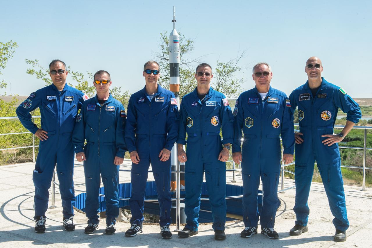 jsc2019e039272 - At the Cosmonaut Hotel crew quarters in Baikonur, Kazakhstan, the Expedition 60 prime and backup crewmembers pose for pictures July 12 as part of pre-launch activities. From left to right are backup crewmembers Soichi Noguchi of the Japan Aerospace Exploration Agency, Sergey Ryzhikov of Roscosmos and Tom Marshburn of NASA and prime crewmembers Drew Morgan of NASA, Alexander Skvortsov of Roscosmos and Luca Parmitano of the European Space Agency. Morgan, Skvortsov and Parmitano will launch July 20 on the Soyuz MS-13 spacecraft from the Baikonur Cosmodrome in Kazakhstan on a mission to the International Space Station...Andrey Shelepin/GCTC.