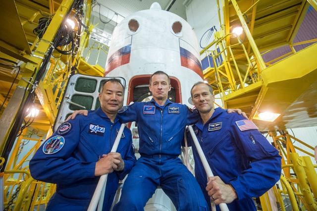 jsc2019e039435 - At the Baikonur Cosmodrome in Kazakhstan, Expedition 60 backup crewmembers Soichi Noguchi of the Japan Aerospace Exploration Agency (left), Sergey Ryzhikov of Roscosmos (center) and Tom Marshburn of NASA (right) pose for pictures in front of the Soyuz MS-13 spacecraft July 16 as part of pre-launch preparations. They are the backups to Drew Morgan of NASA, Alexander Skvortsov of Roscosmos and Luca Parmitano of the European Space Agency who will launch July 20 on the Soyuz MS-13 spacecraft from the Baikonur Cosmodrome for a mission on the International Space Station...Andrey Shelepin/GCTC.