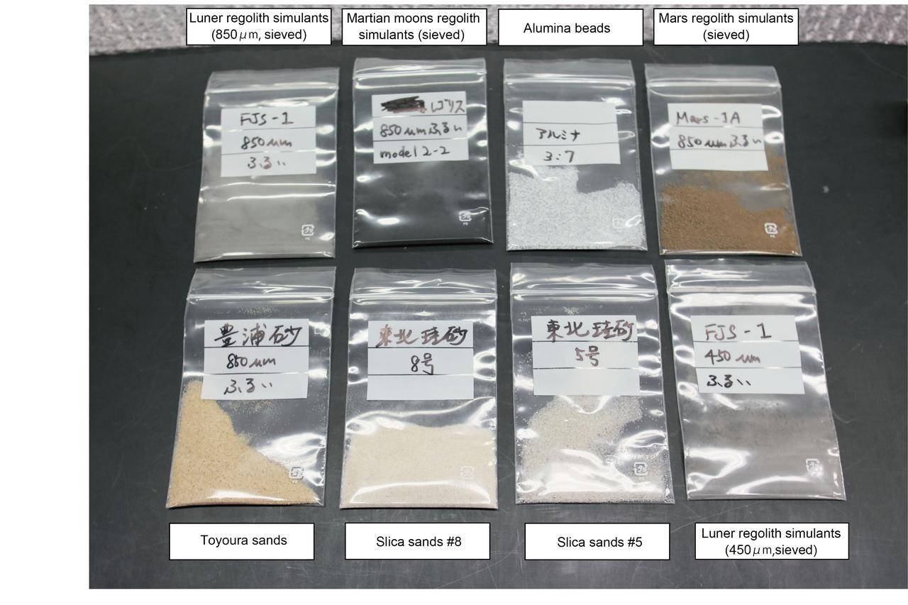 View of Hourglass samples including Lunar regolith simulants, Martian moons regolith simulants, Alumina beads, Mars regolith simulants, Toyoura sands and Slica sands. (Image courtesy of: JAXA)