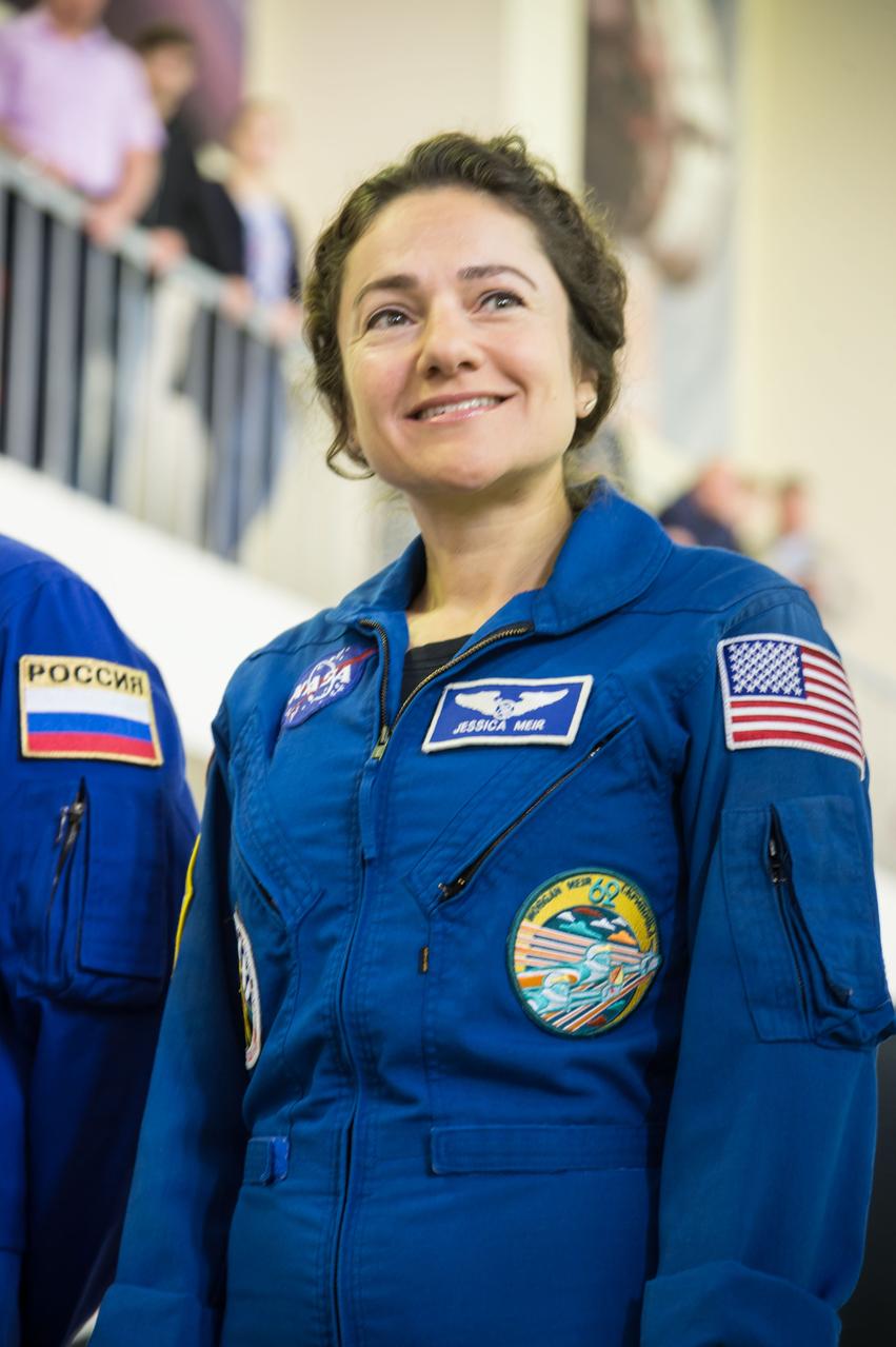 jsc2019e051808 - At the Gagarin Cosmonaut Training Center in Star City, Russia, Expedition 61 crewmember Jessica Meir of NASA listens to a reporter’s question Aug. 29 during the first day of the crew’s qualification exams for flight. Meir, Oleg Skripochka of Roscosmos and United Arab Emirates spaceflight participant Hazzaa Ali Almansoori will launch Sept. 25 from the Baikonur Cosmodrome in Kazakhstan on the Soyuz MS-15 spacecraft for a mission on the International Space Station...NASA/Beth Weissinger.