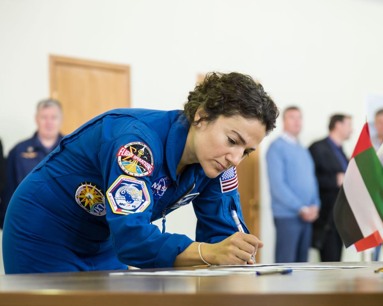 jsc2019e051812 - At the Gagarin Cosmonaut Training Center in Star City, Russia, Expedition 61 crewmember Jessica Meir of NASA signs in for the first day of crew qualification exams Aug. 29. Meir, Oleg Skripochka of Roscosmos and United Arab Emirates spaceflight participant Hazzaa Ali Almansoori will launch Sept. 25 from the Baikonur Cosmodrome in Kazakhstan on the Soyuz MS-15 spacecraft for a mission on the International Space Station...NASA/Beth Weissinger.