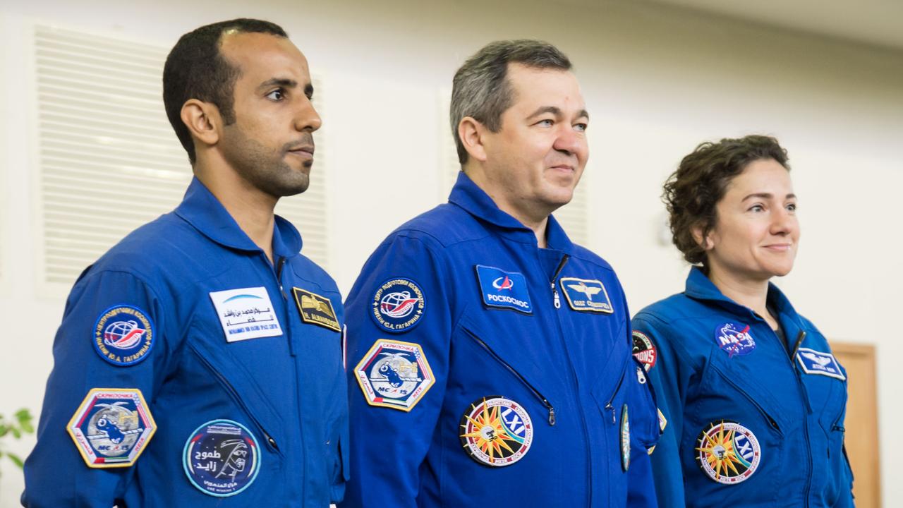 jsc2019e051814 - At the Gagarin Cosmonaut Training Center in Star City, Russia, the next crew to launch to the International Space Station reports to Russian, American and United Arab Emirates space officials Aug. 29 during their final qualification exams for flight. From left to right are United Arab Emirates spaceflight participant Hazzaa Ali Almansoori, and Expedition 61 crewmembers Oleg Skripochka of Roscosmos and Jessica Meir of NASA. They will launch Sept. 25 from the Baikonur Cosmodrome in Kazakhstan on the Soyuz MS-15 spacecraft...NASA/Beth Weissinger.