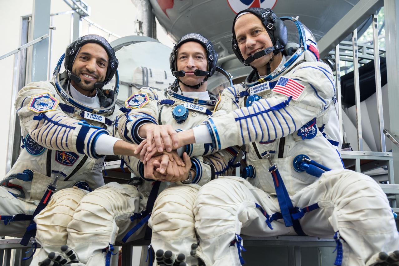 jsc2019e051815 - At the Gagarin Cosmonaut Training Center in Star City, Russia, the backups to the next crew to launch to the International Space Station posed for pictures Aug. 29 during the first day of crew qualification exams. From left to right are backup spaceflight participant Sultan Al-Neyadi of the United Arab Emirates, Sergey Ryzhikov of Roscosmos and Tom Marshburn of NASA. They are the backups to the prime crew, spaceflight participant Hazzaa Ali Almansoori of the United Arab Emirates and Expedition 61 crewmembers Oleg Skripochka of Roscosmos and Jessica Meir of NASA, who will launch Sept. 25 from the Baikonur Cosmodrome in Kazakhstan on the Soyuz MS-15 spacecraft...NASA/Beth Weissinger.