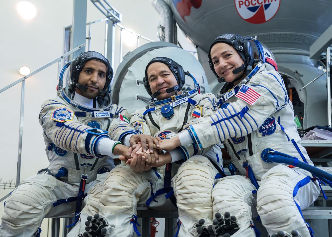 jsc2019e051849 - At the Gagarin Cosmonaut Training Center in Star City, Russia, spaceflight participant Hazzaa Ali Almansoori of the United Arab Emirates (left), Oleg Skripochka of Roscosmos (center) and Jessica Meir of NASA (right) pose for pictures Aug. 30 during crew qualification exams. They will launch Sept. 25 on the Soyuz MS-15 spacecraft from the Baikonur Cosmodrome in Kazakhstan for a mission on the International Space Station...NASA/Beth Weissinger.